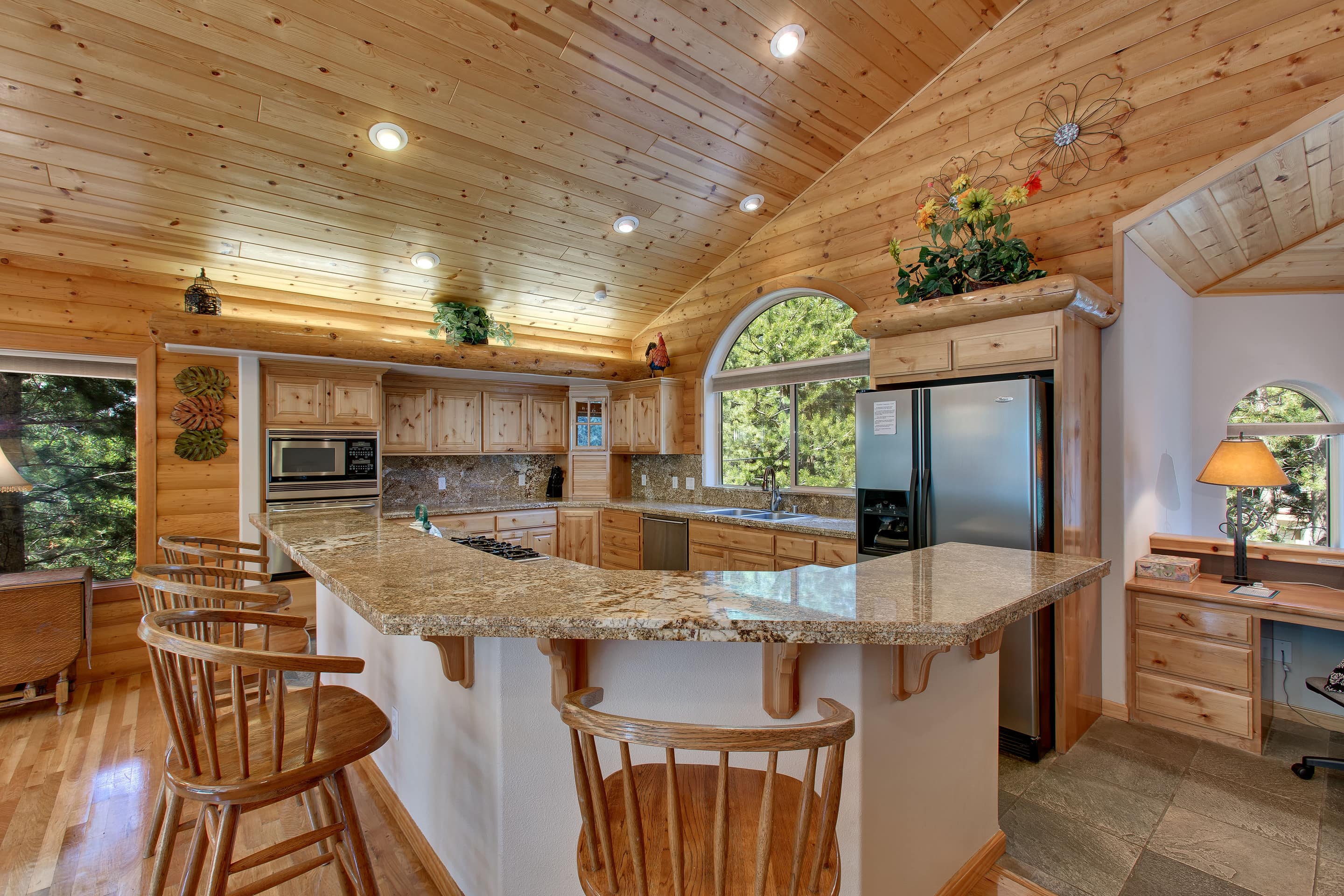 This is a kitchen with a large island and wood accents.