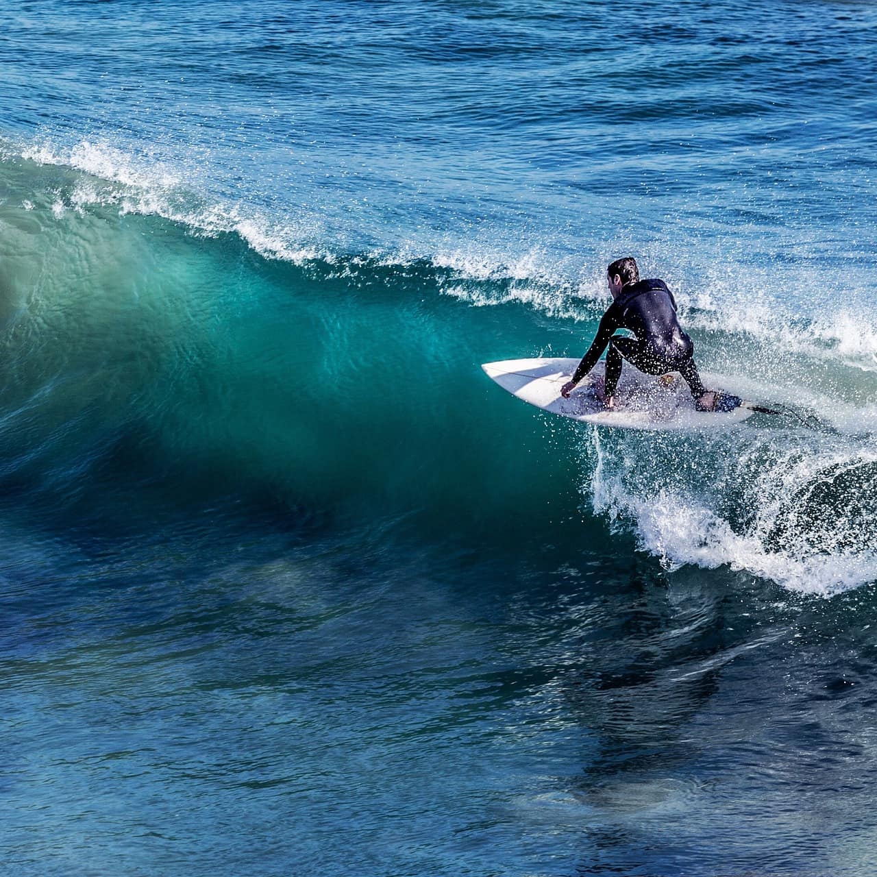A surfer rides a barrel wave.