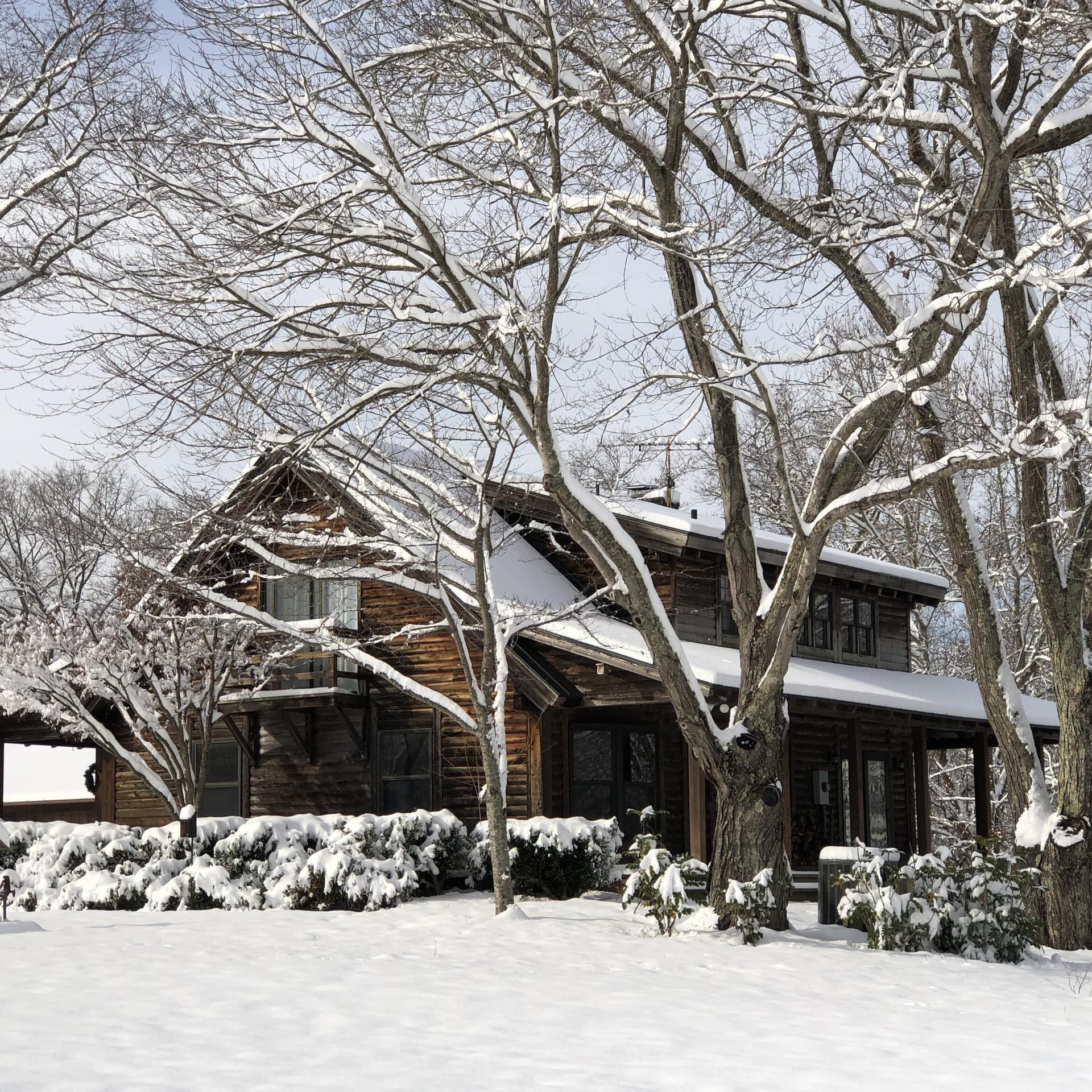 A 2-story log cabin in the snow