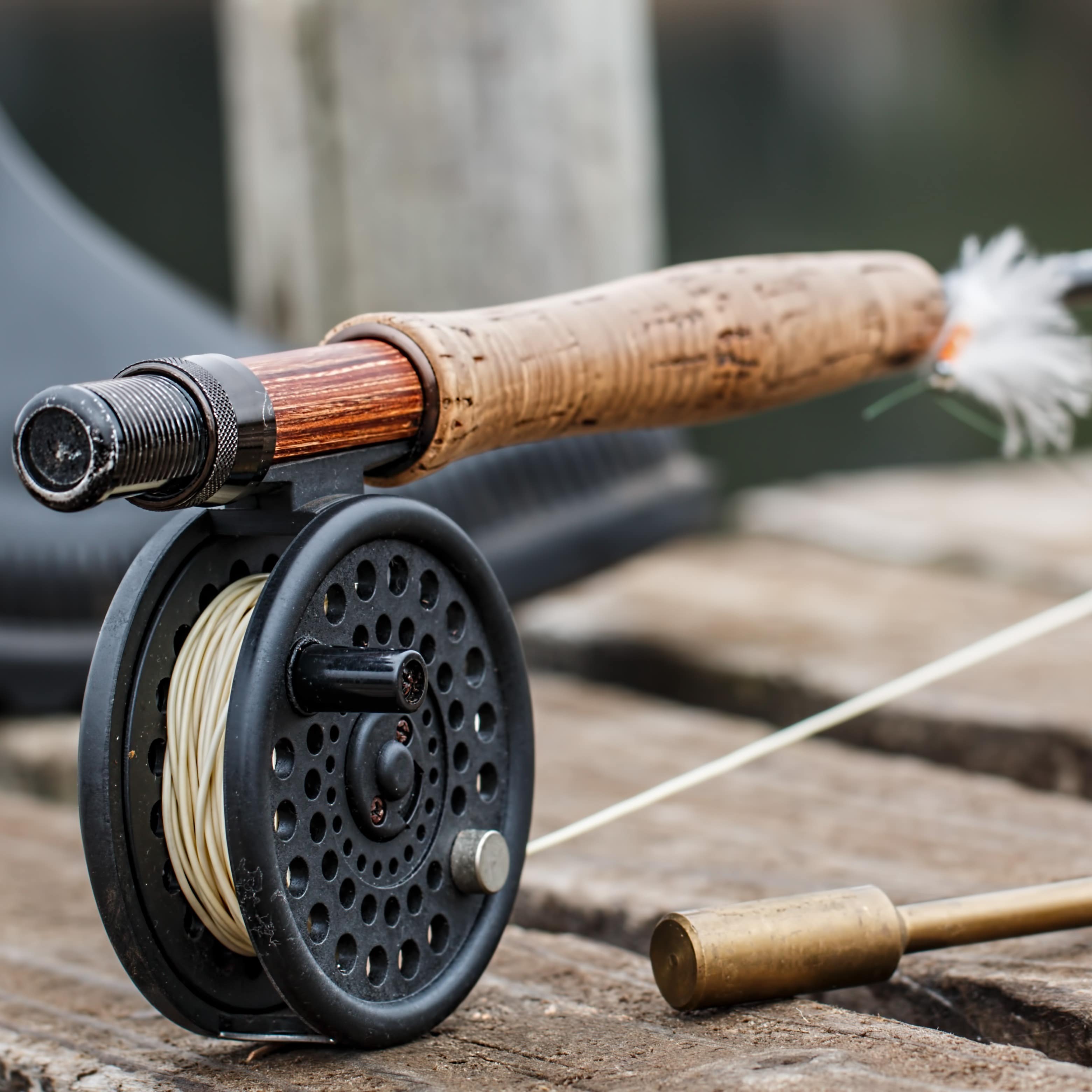 A fly fishing rod on a wood dock