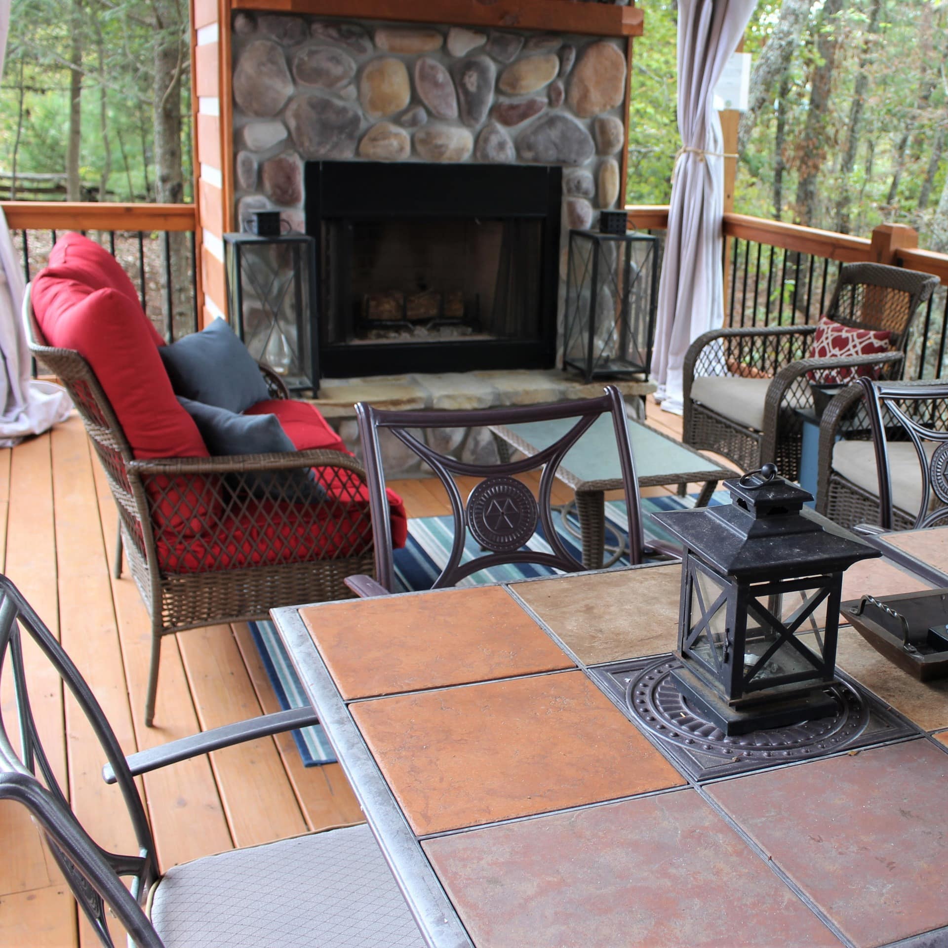 Cozy patio furniture on a spacious deck with a fireplace