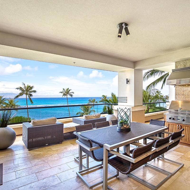 A high-class kitchen and terrace area overlooks the waters and palms of Kapalua Beach