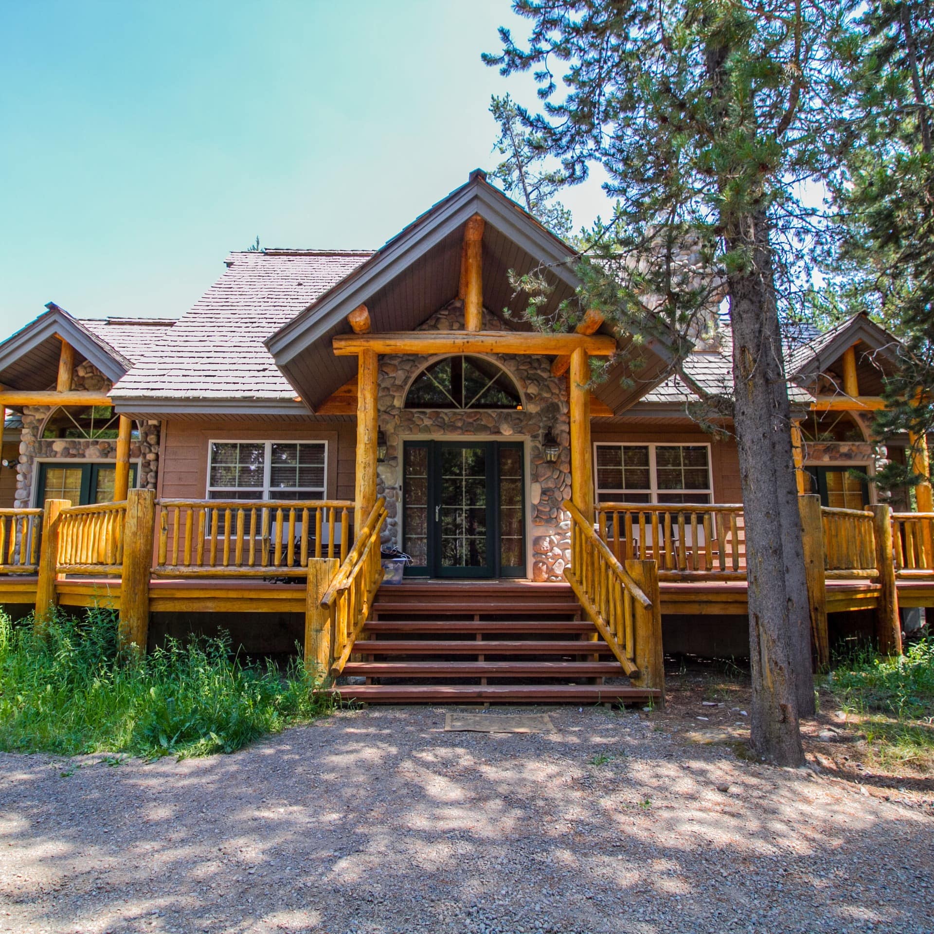 Wood and stone cabin with a deck