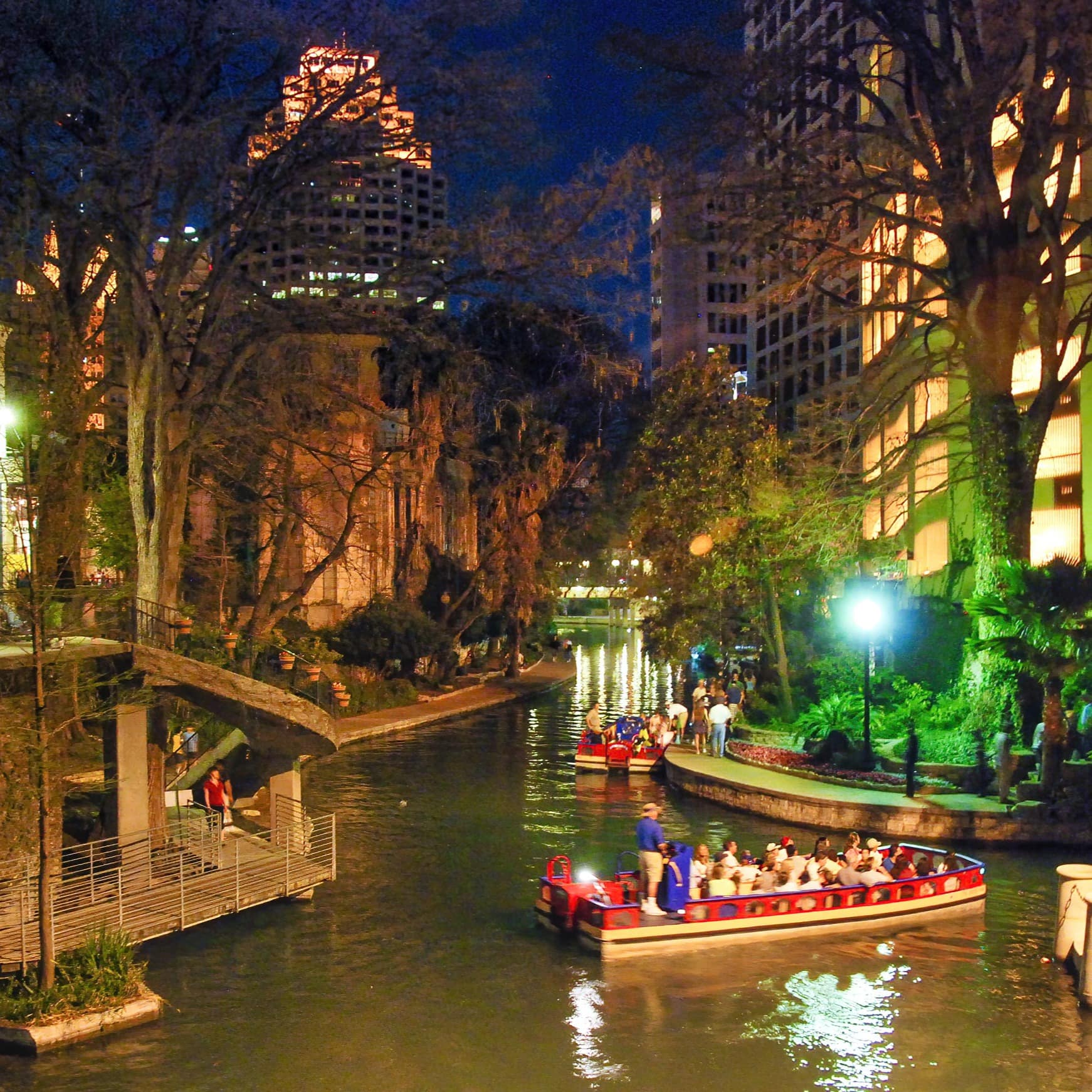 People in boat on the riverwalk at night in San Antonio, Texas