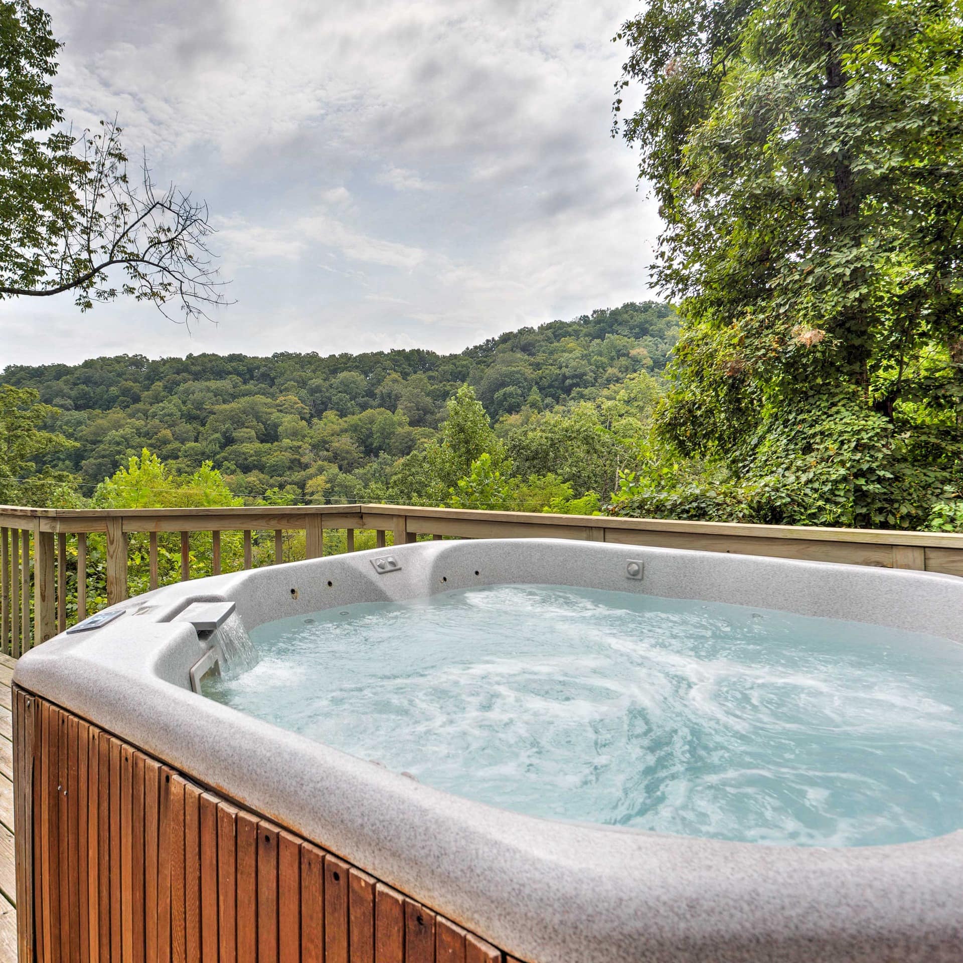Hot tub on a wooden deck with view over tree tops
