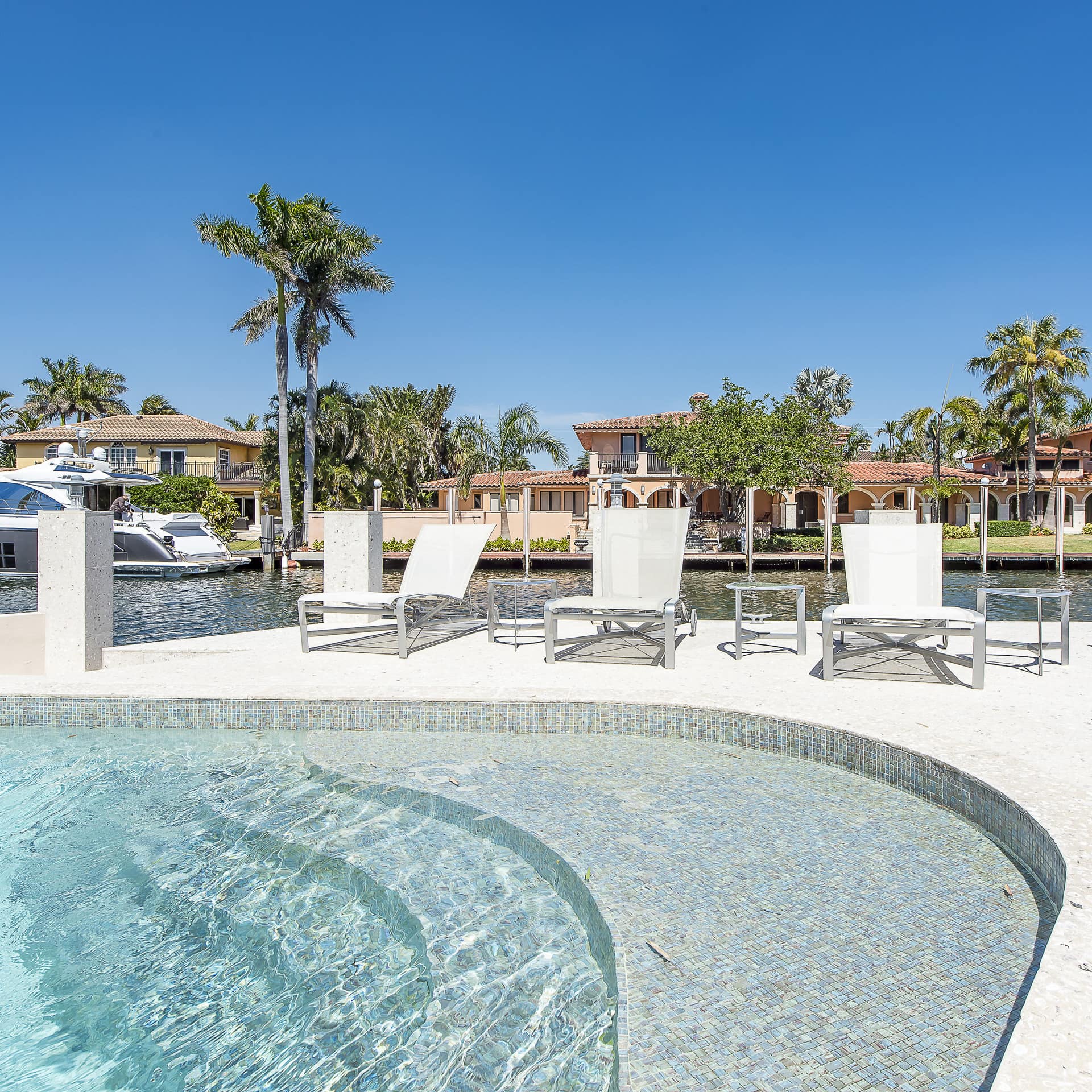 A sunny villa pool with sunbeds in Las Olas Seven Isles
