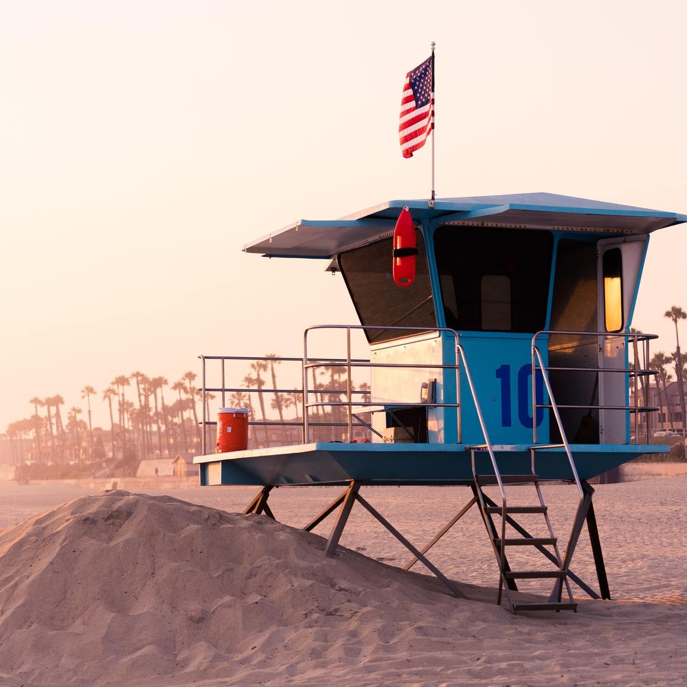 A lifeguard station on Huntingdon Beach in the sunset