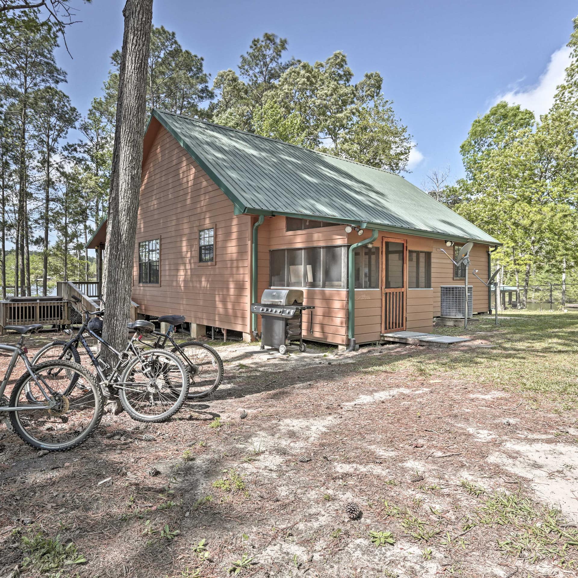 Bikes rest on pine trees outside a pink-tinted cottage in Texas