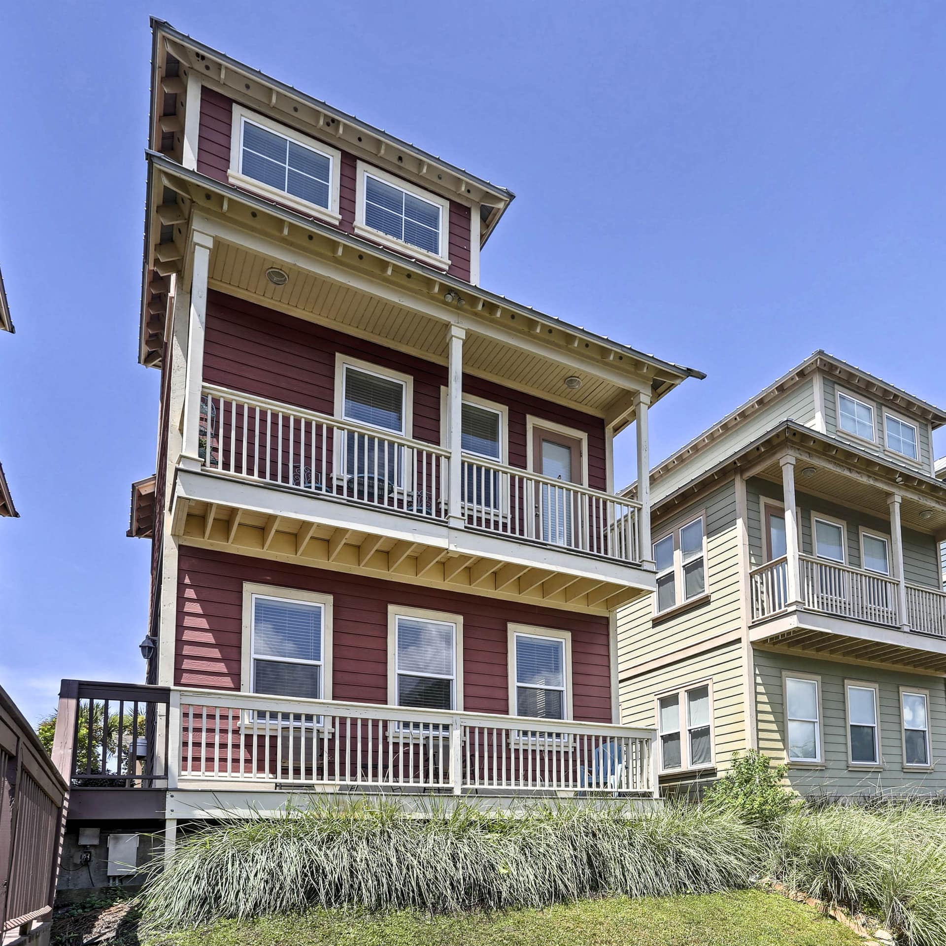 A line of handsome, wood-paneled coast homes, each with a balcony