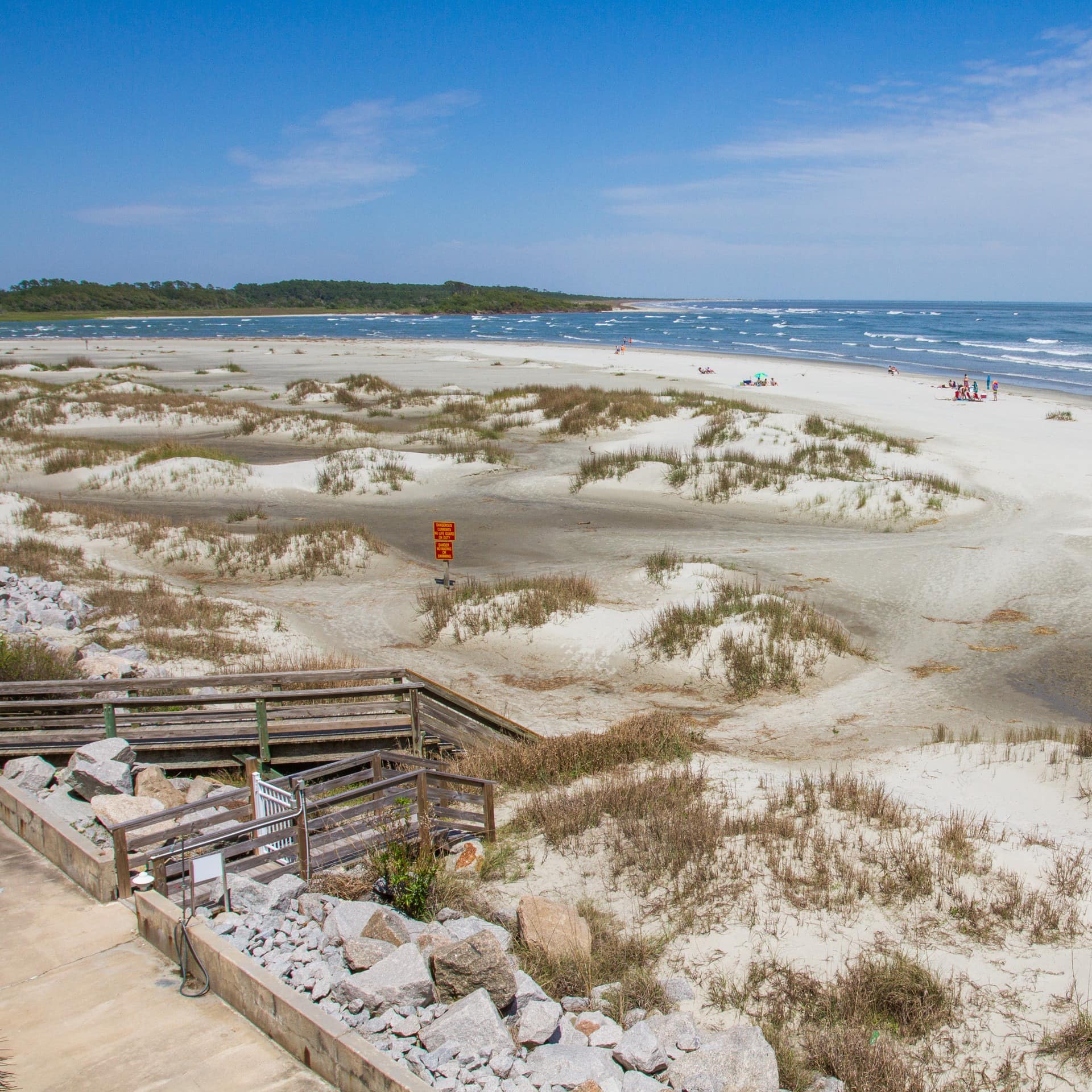 A boardwalk leads straight from a North Myrtle Beach house rental to the shimmering beaches and sand dunes