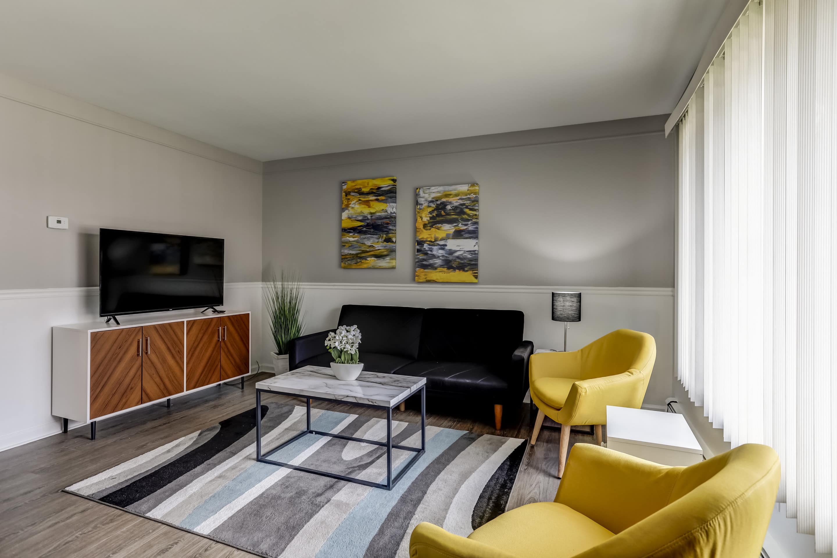 Trendy Detroit apartment with yellow armchairs