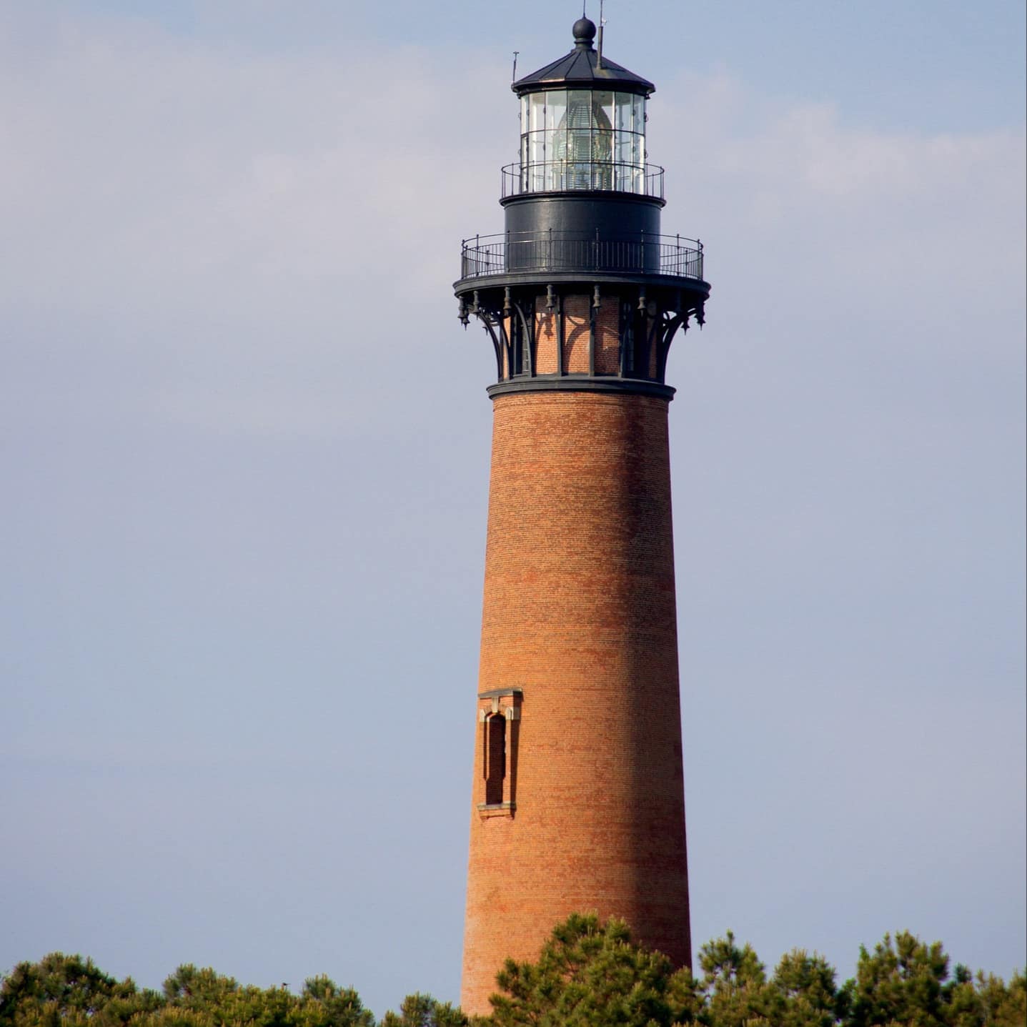 The Currituck Beach Lighthouse rising above the trees.