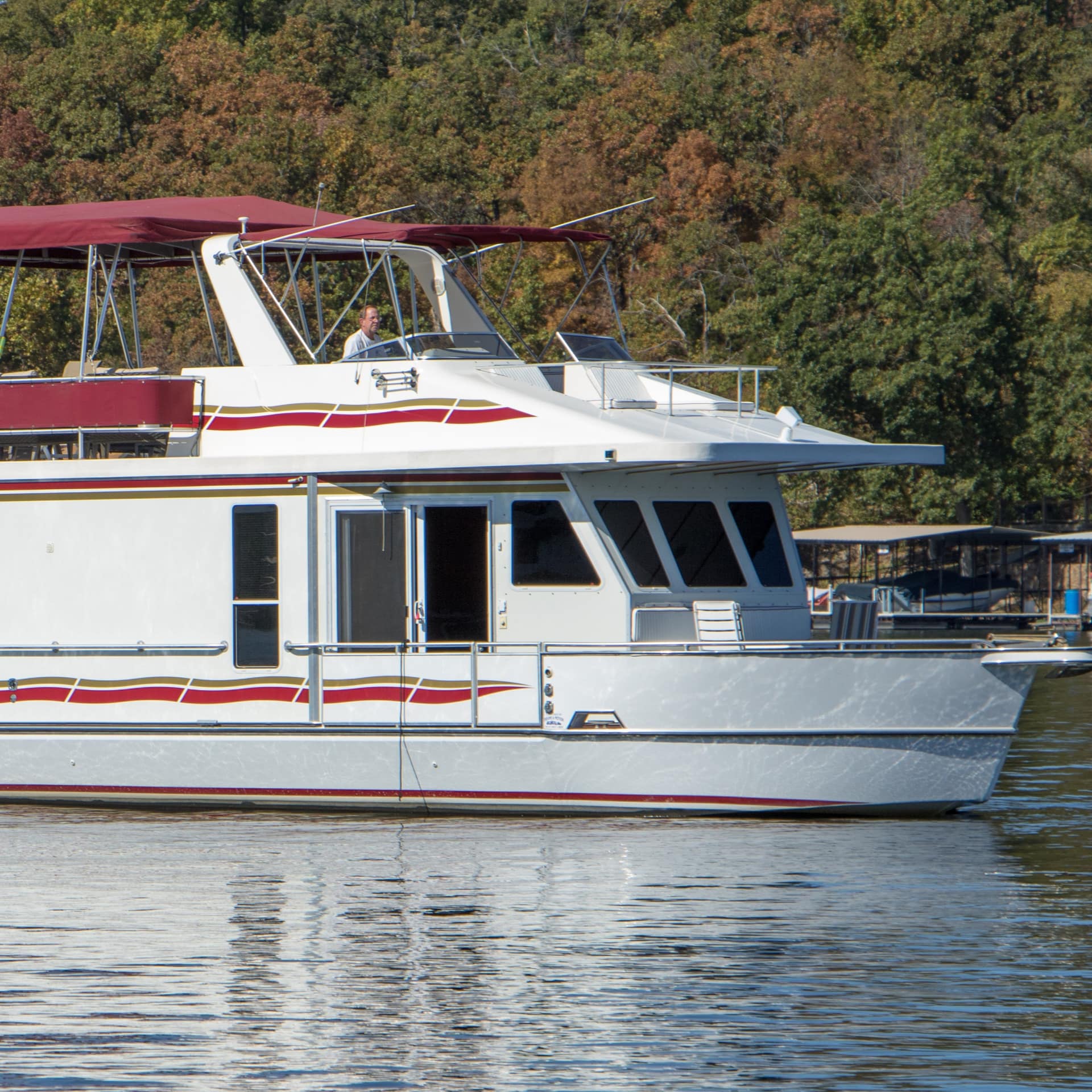 A luxury houseboat cruises near the Lake of the Ozarks State Park in Missouri