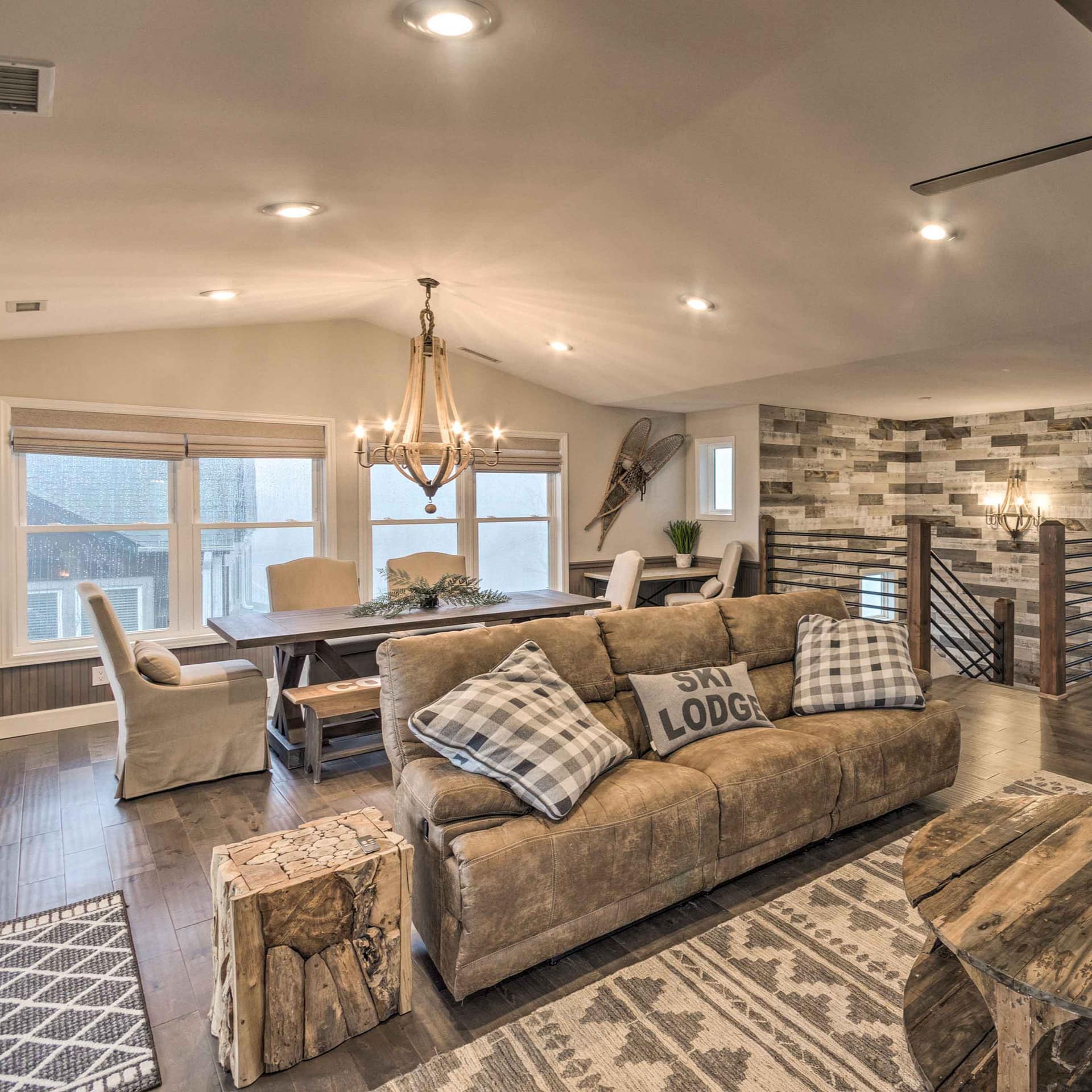 This Beech Mountain Ski Resort rental cabin features a modern interior with rustic wood and stone accents.