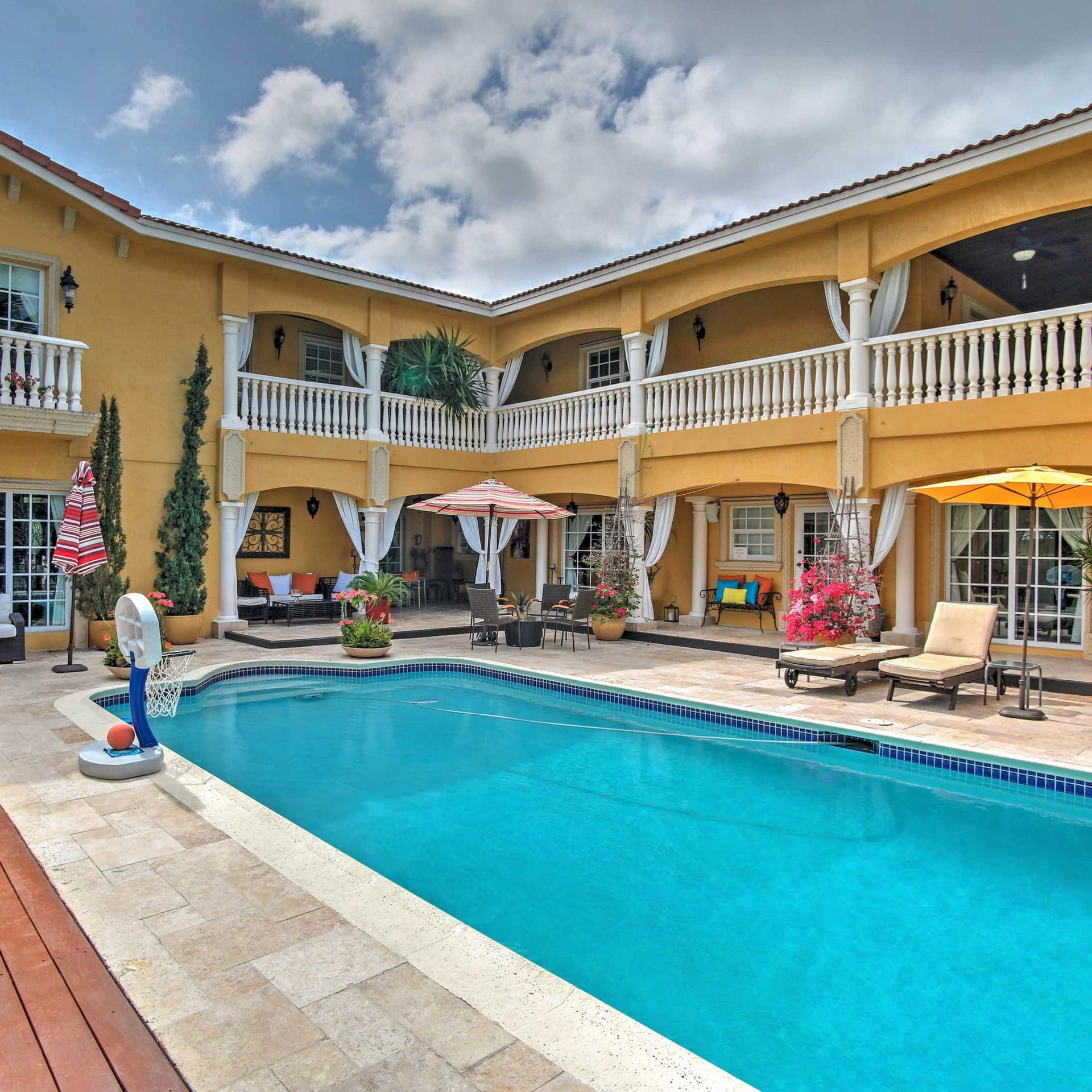 A large and colorful Miami mansion with a private pool and a Spanish-flavored design
