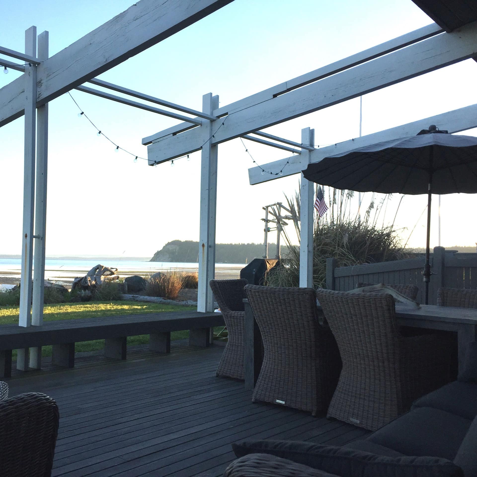 Modern deck chairs on a porch overlooking a beach