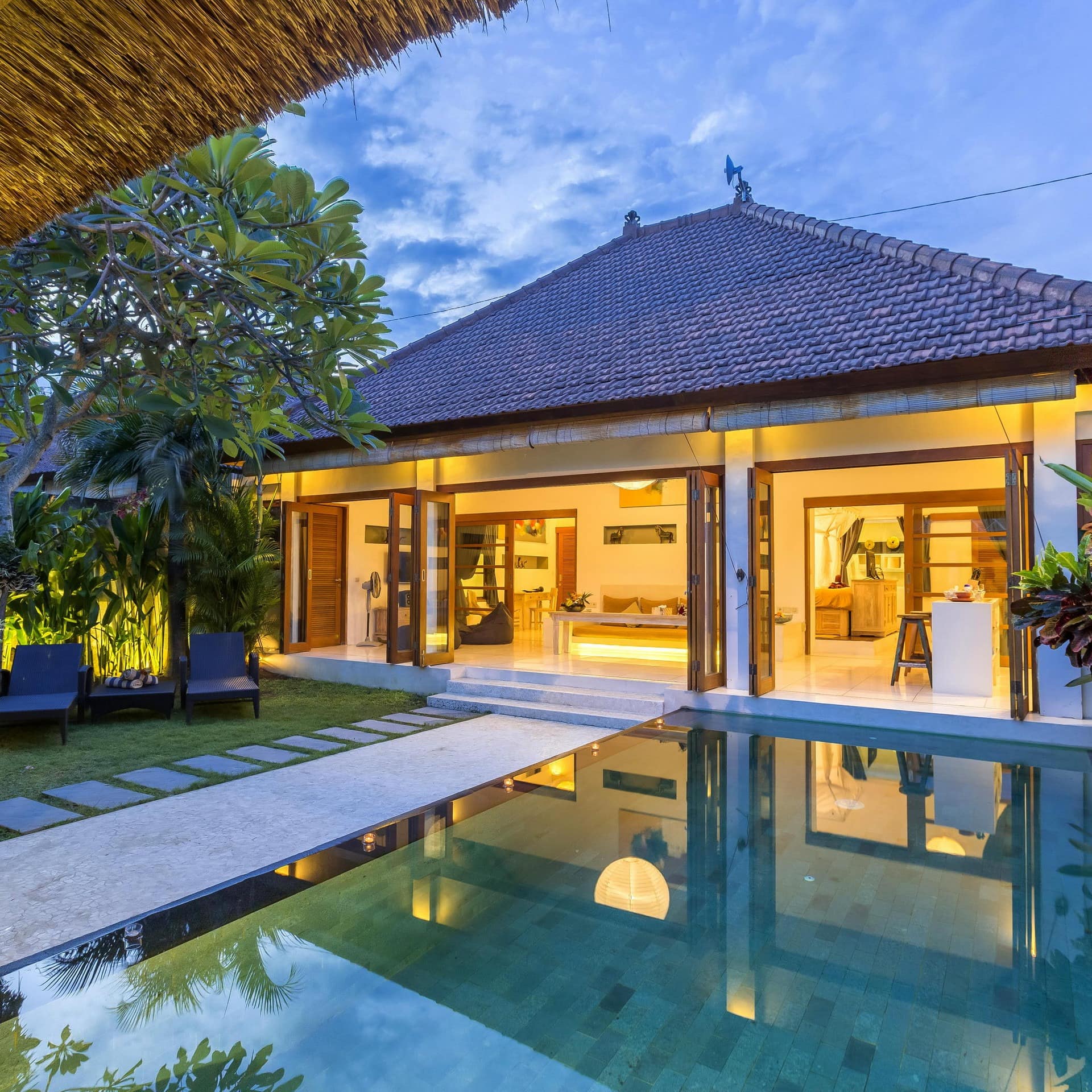 A luxury Balinese cottage with a swimming pool in a garden