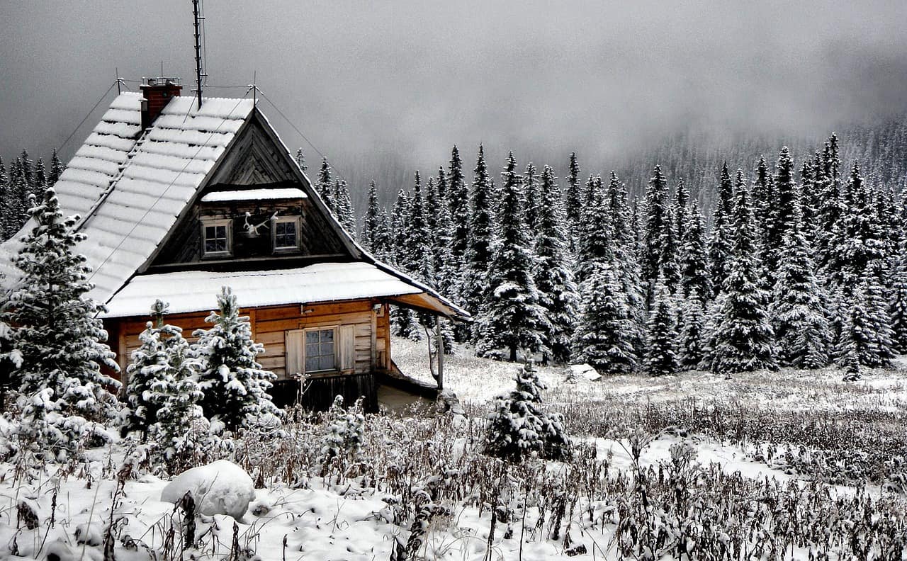 A snowed-covered cabin in the mountains