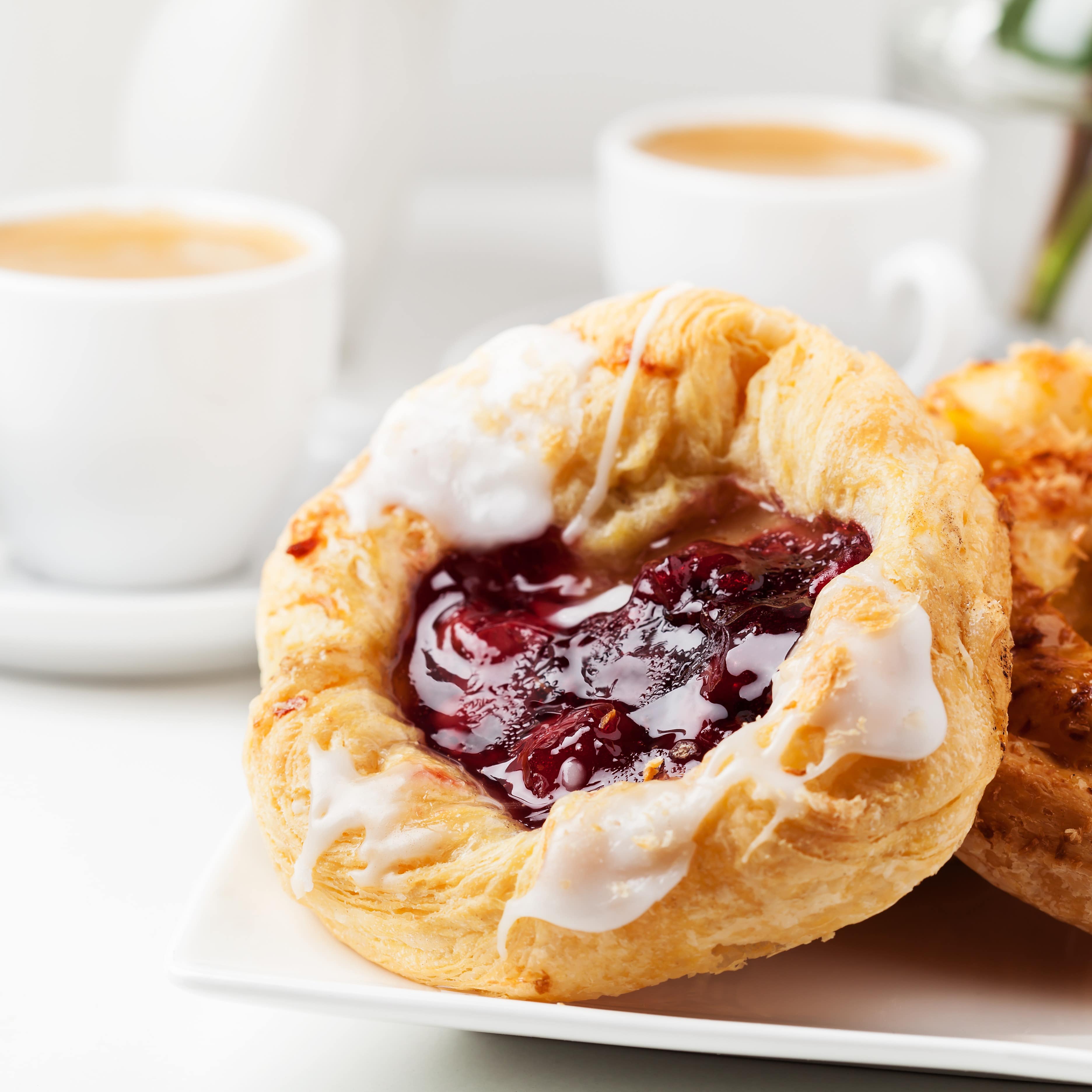Danish pastries with coffee in background