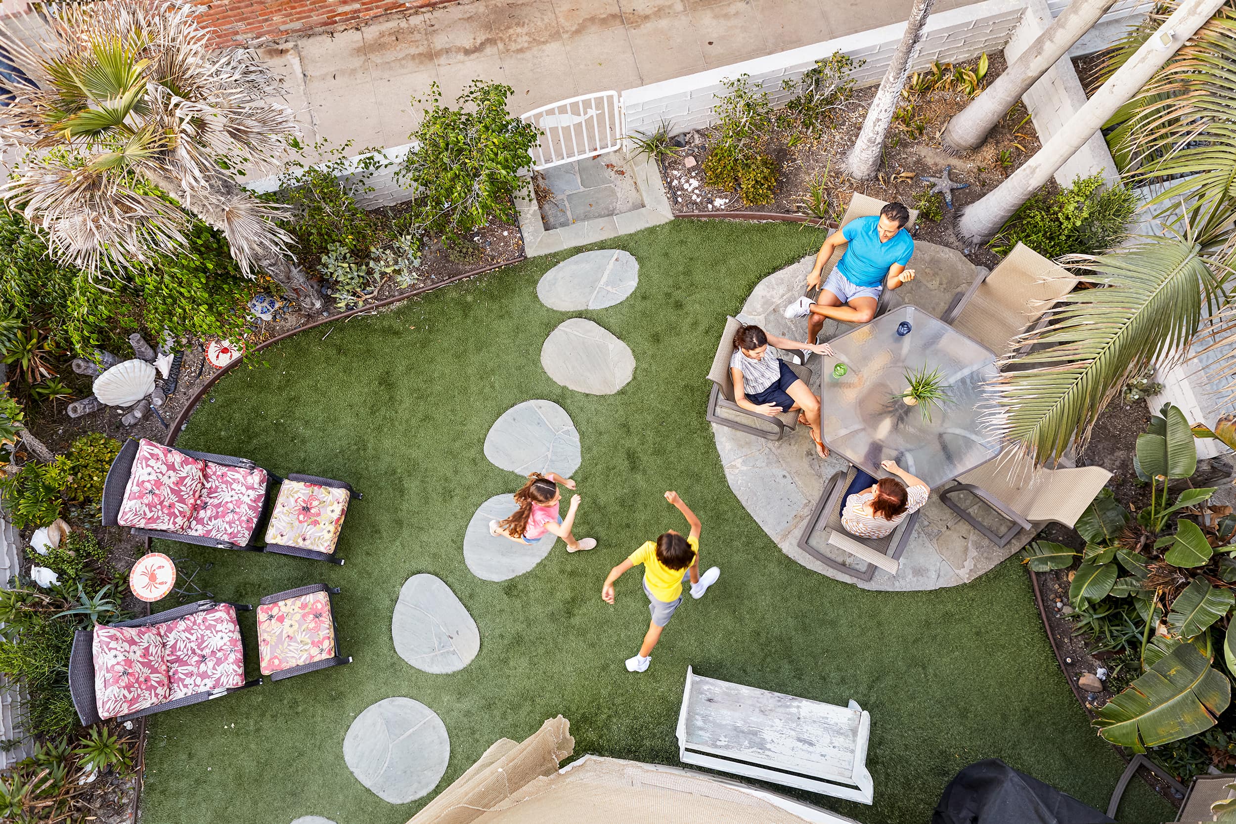 Aerial shot of family spending time together in backyard.