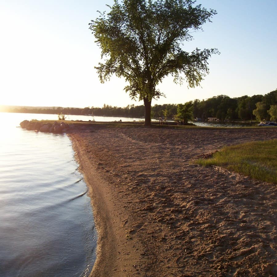 A shot of the Lake Leelanau waterfront and its powdery beach as the sun is setting