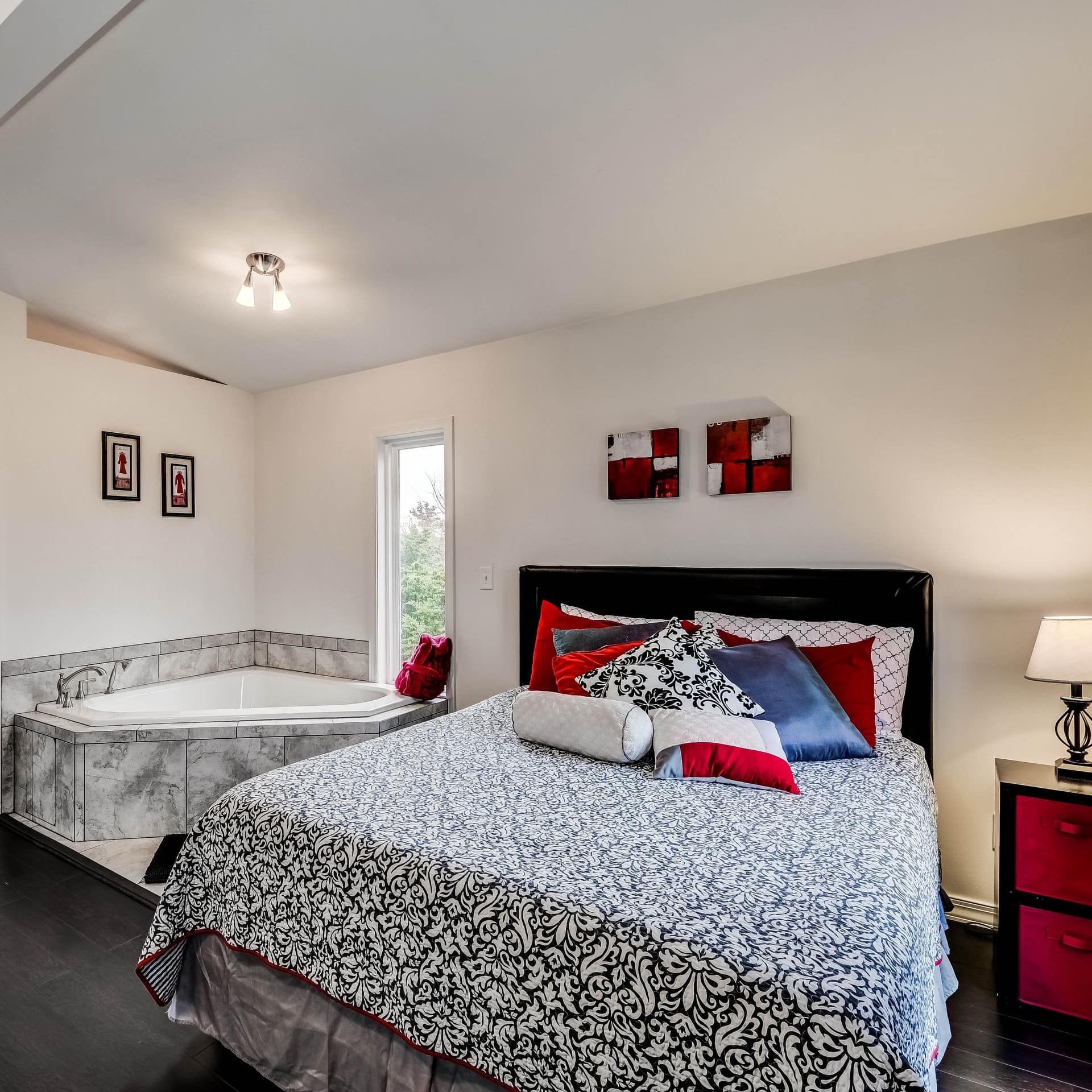 This romantic cabin rental in Oklahoma features a bedroom with a jetted tub offering garden views.