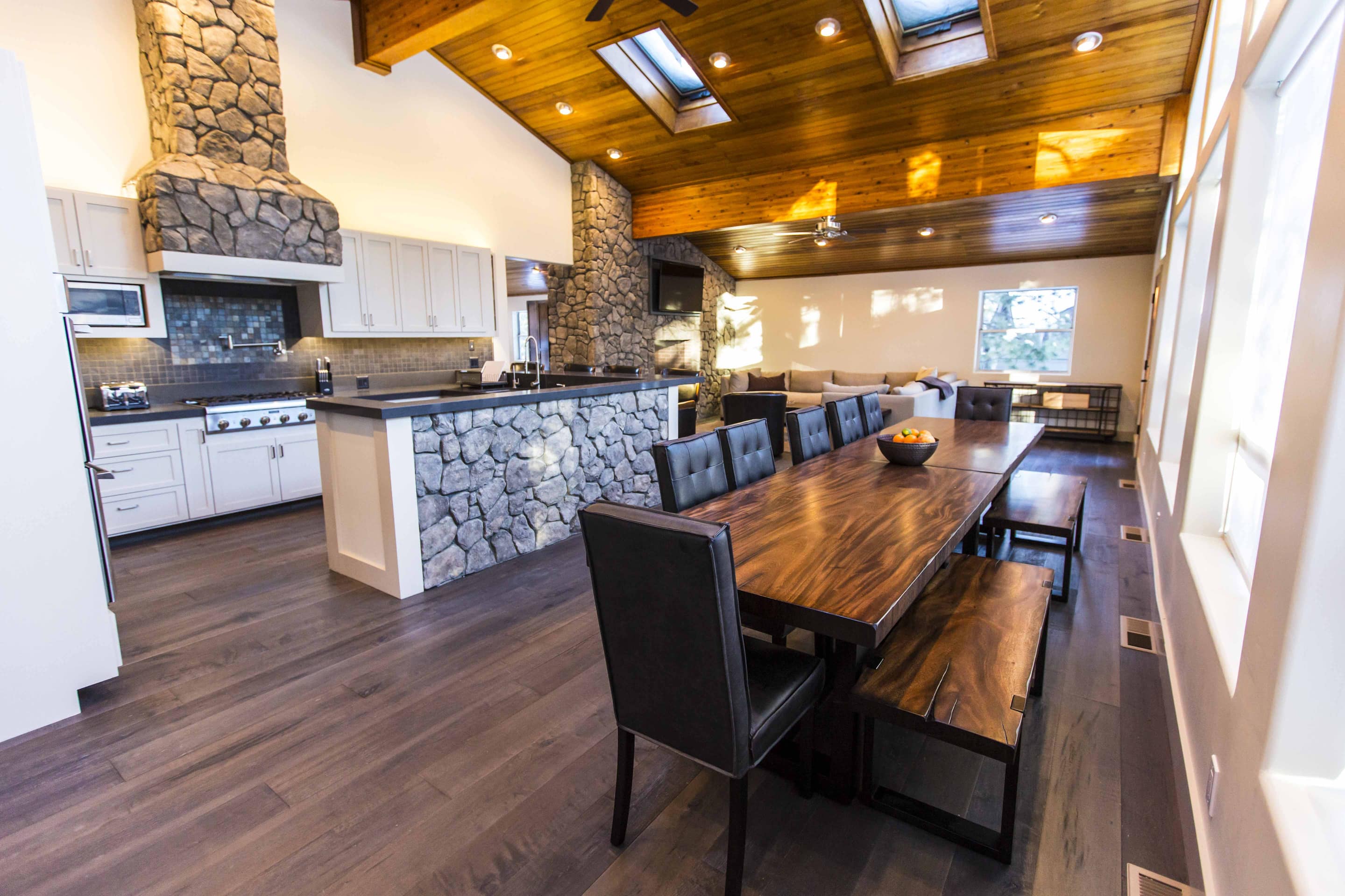 This is a unique kitchen with stone accents on the range hood and counter.