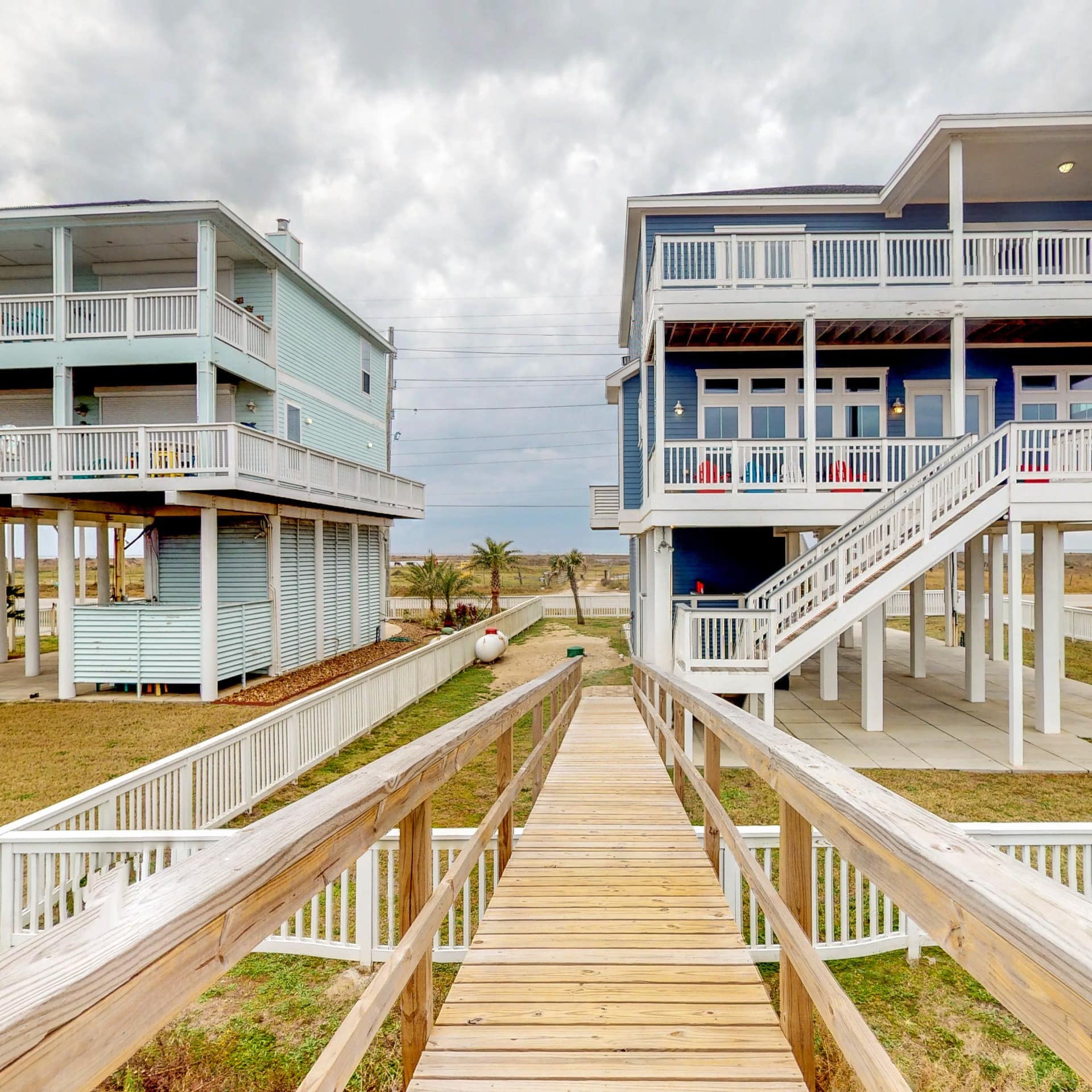 A double-deck and boardwalk reaches a luxury beach house in Galveston, TX