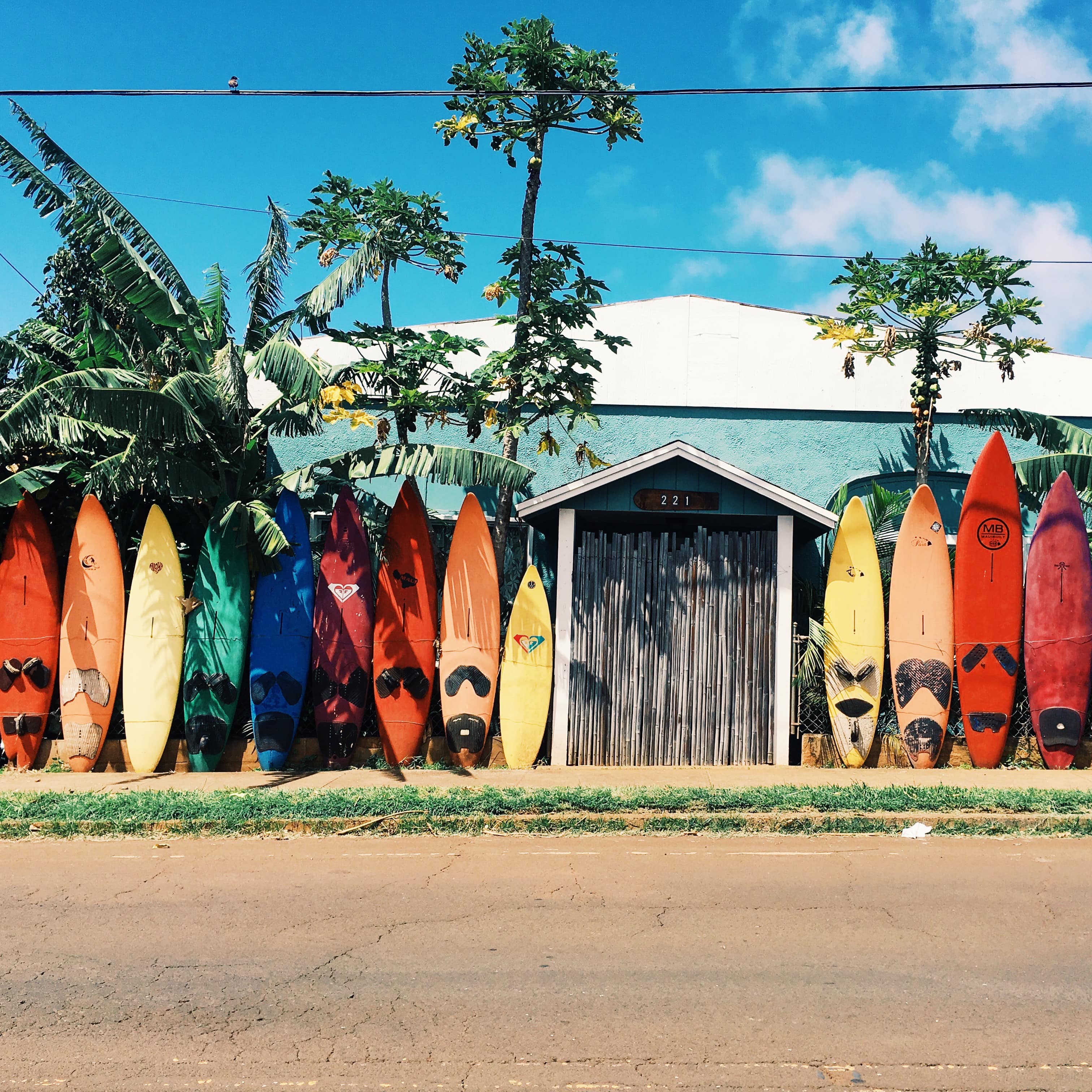 Colorful surfboards lined up in front of a house in Maui, Hawaii