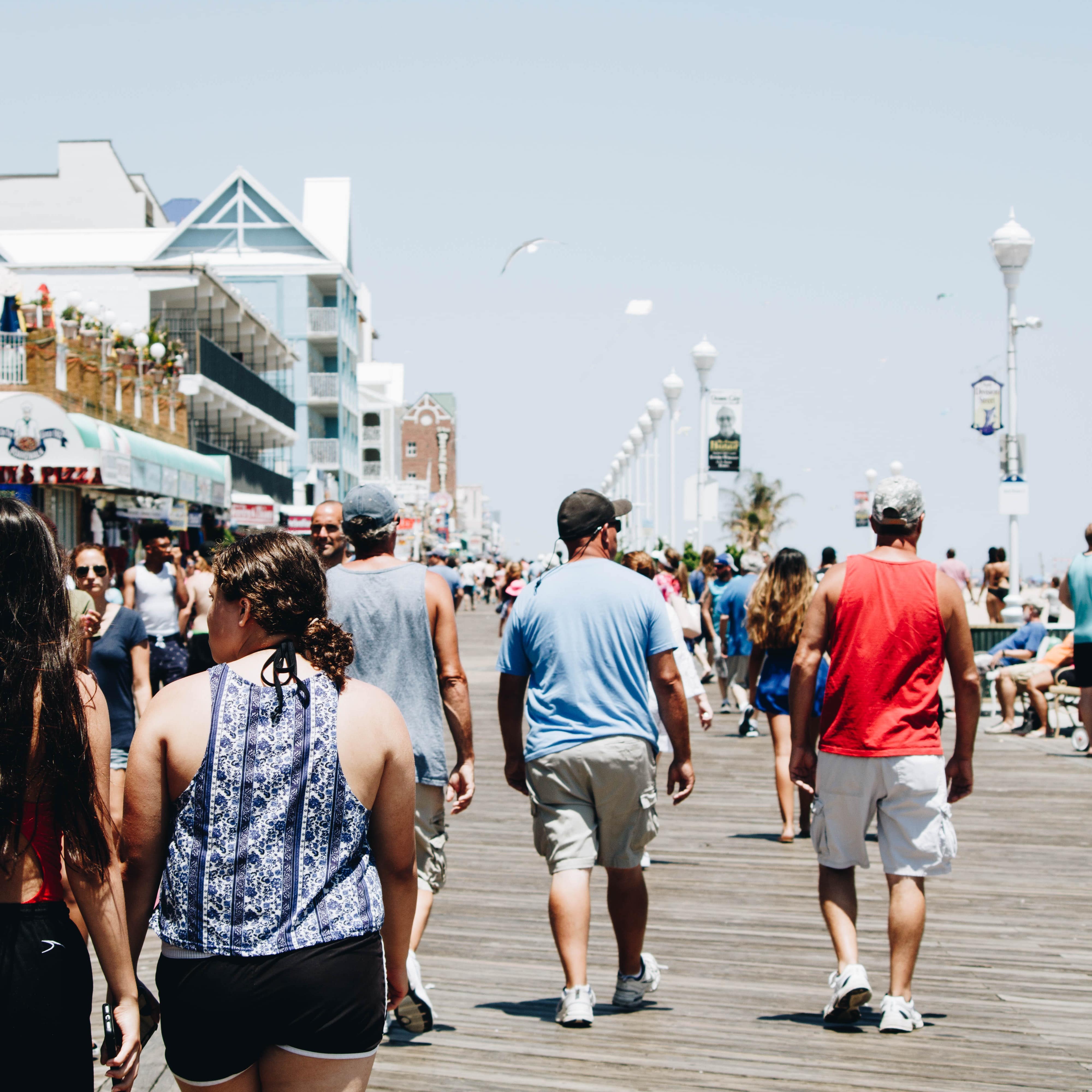 People strolling along Ocean City's boardwalk on a sunny day