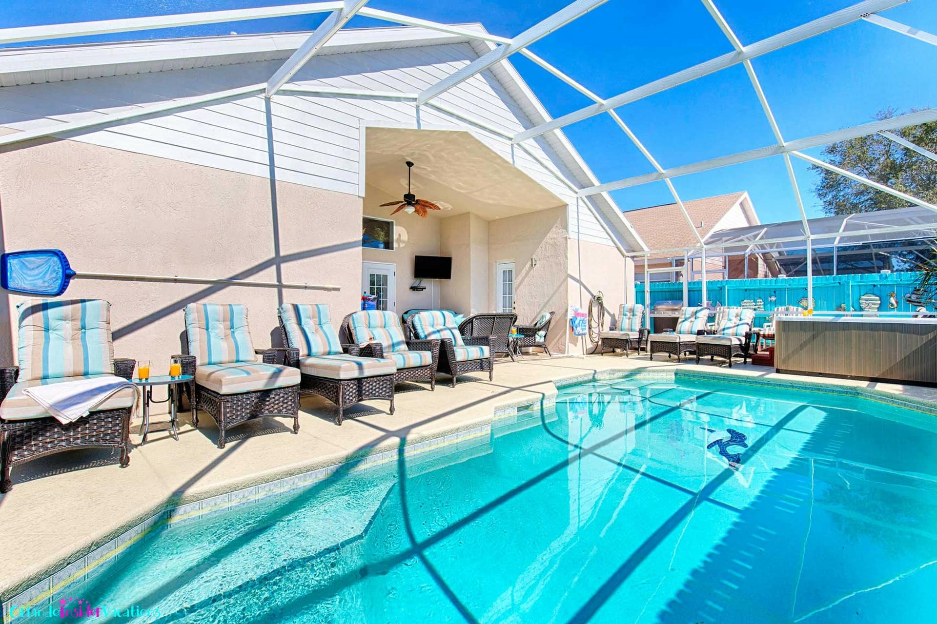 Private pool with luxurious rattan padded chaise loungers and recliners
