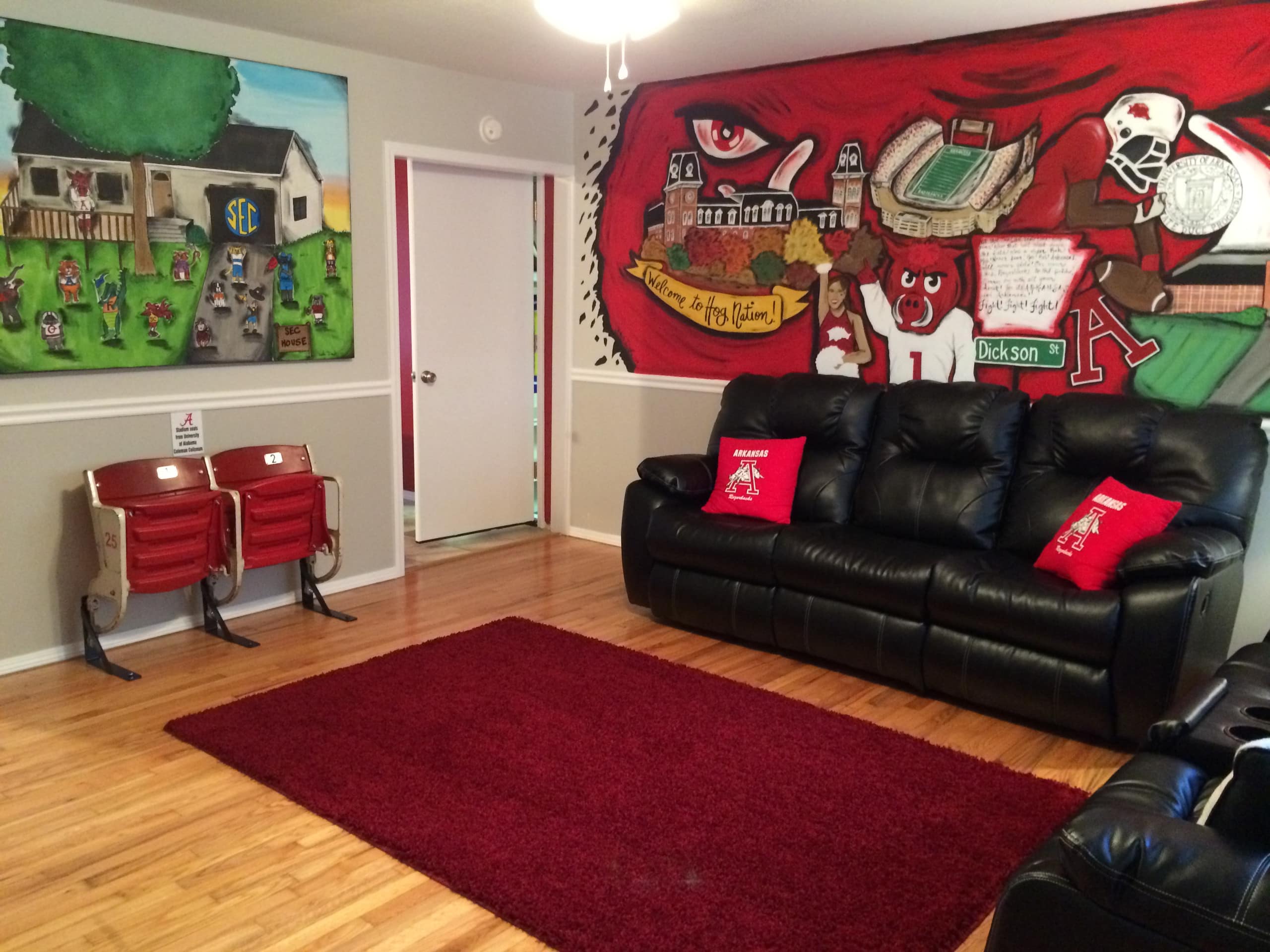 This SEC-themed house has a Razorbacks painted mural wall, an SEC wall hanging, and quirky stadium seats.