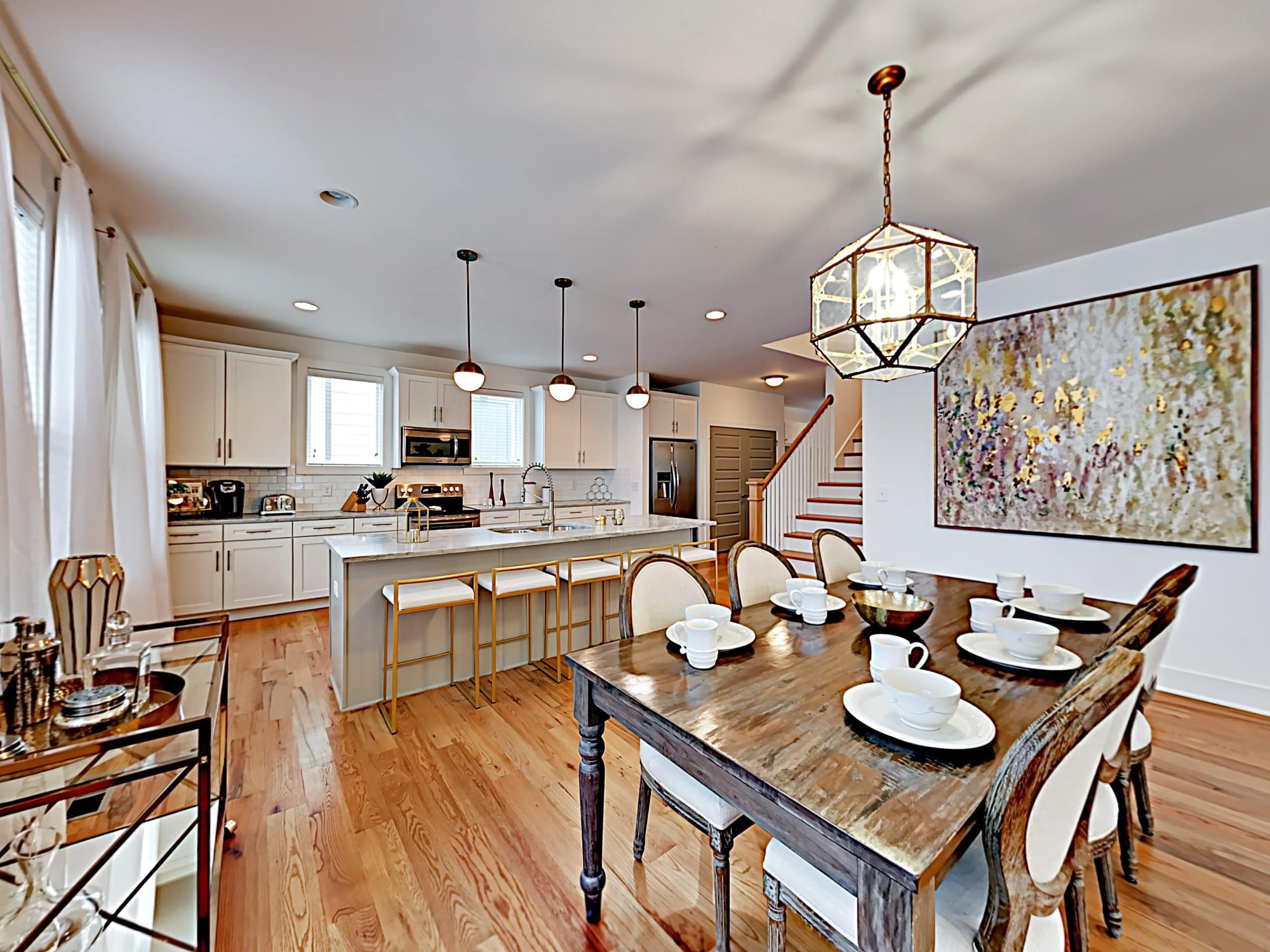 This is a modern kitchen with large dining table.
