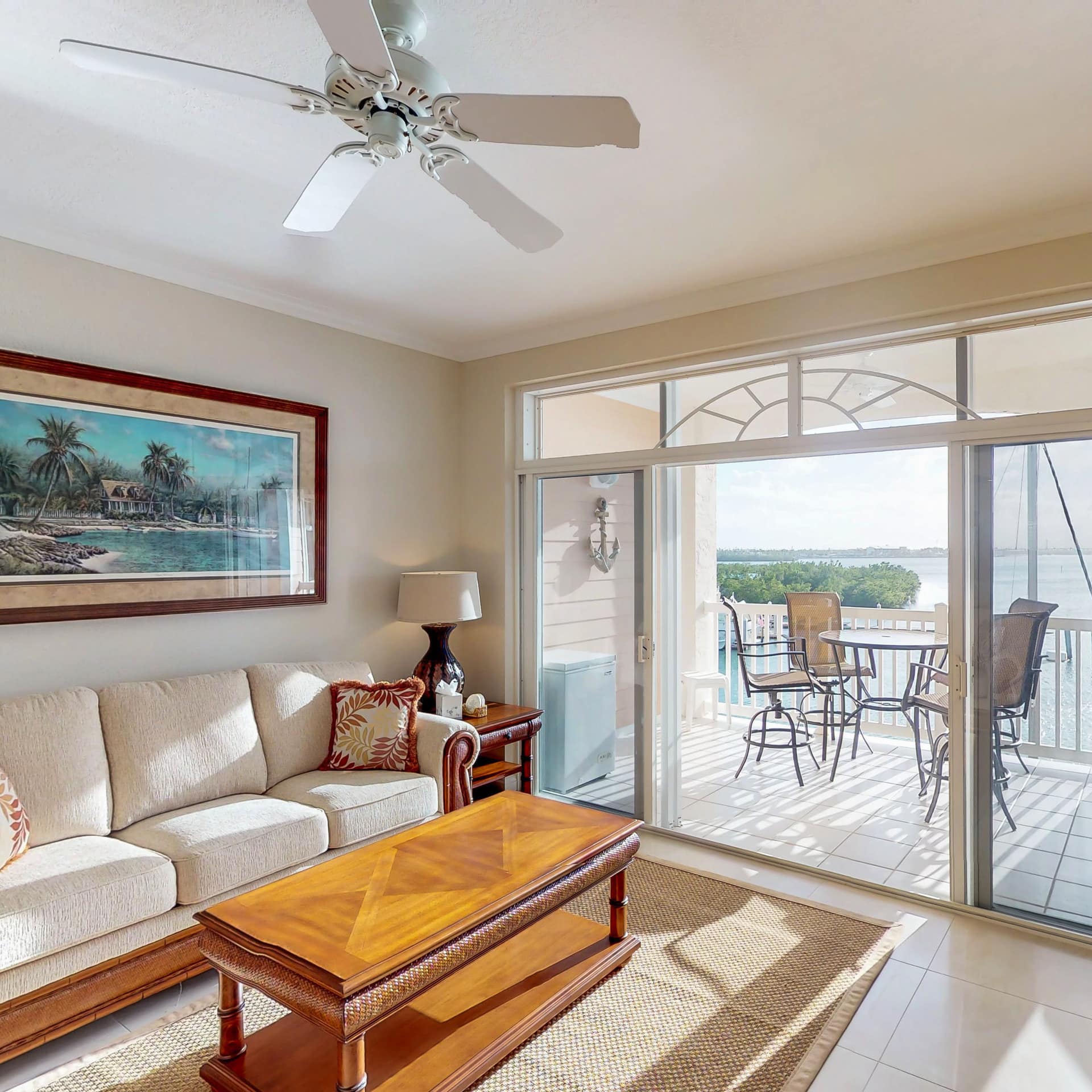 A pet-friendly condo rental's living room and deck, with water views