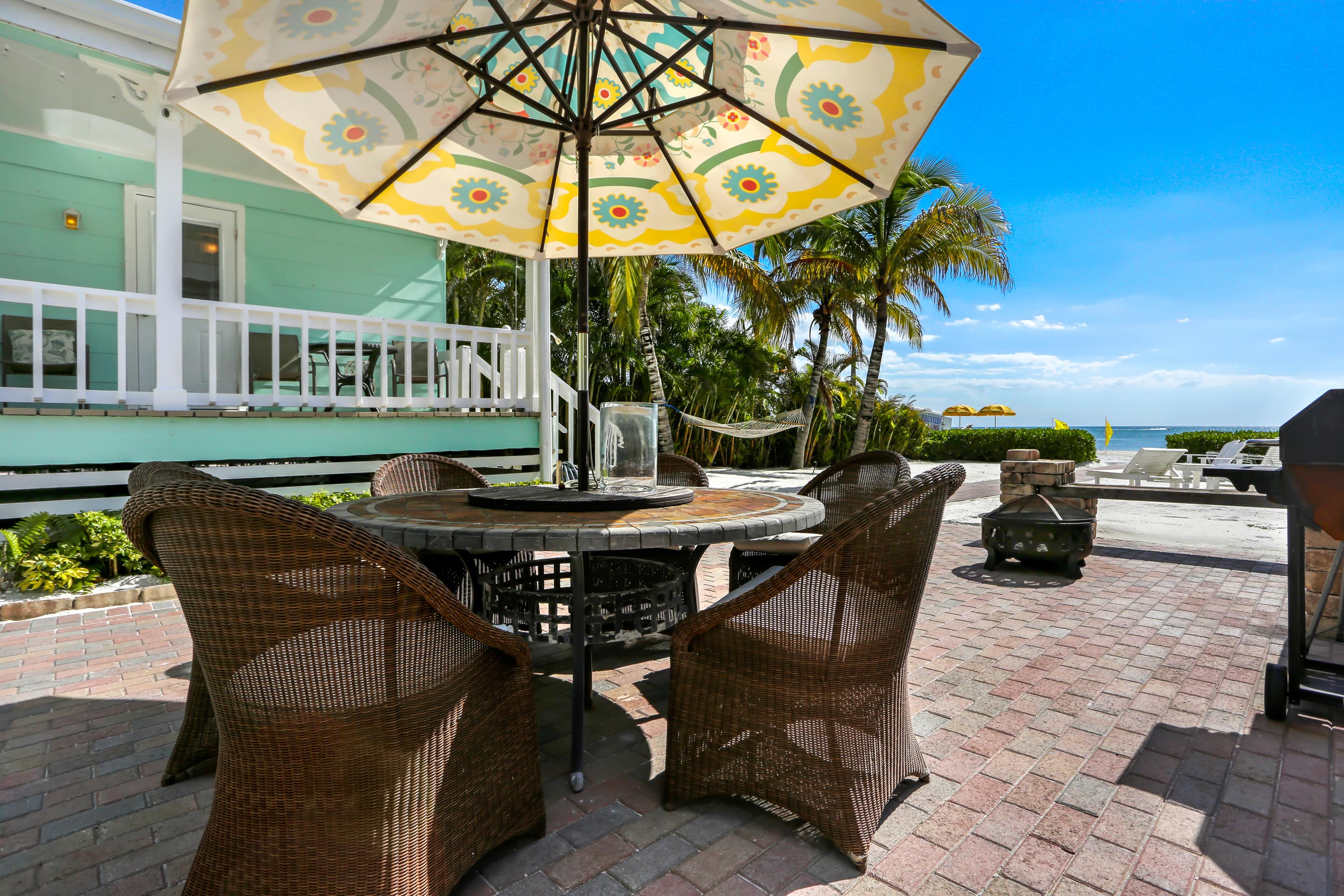This beach-front cottage has a large patio on the sand for outdoor dining.