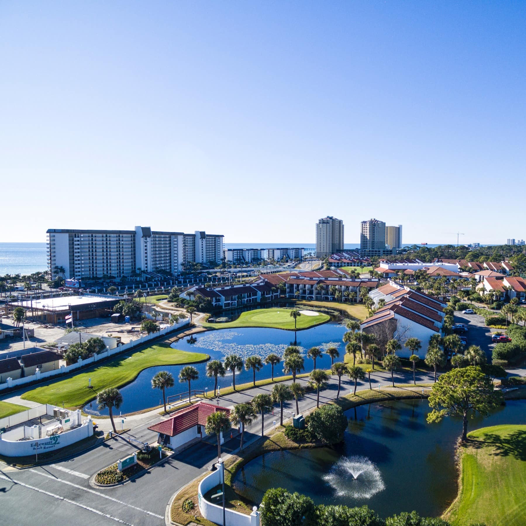 A view across Panama City Beach that has lakes, lawns, houses and condo blocks