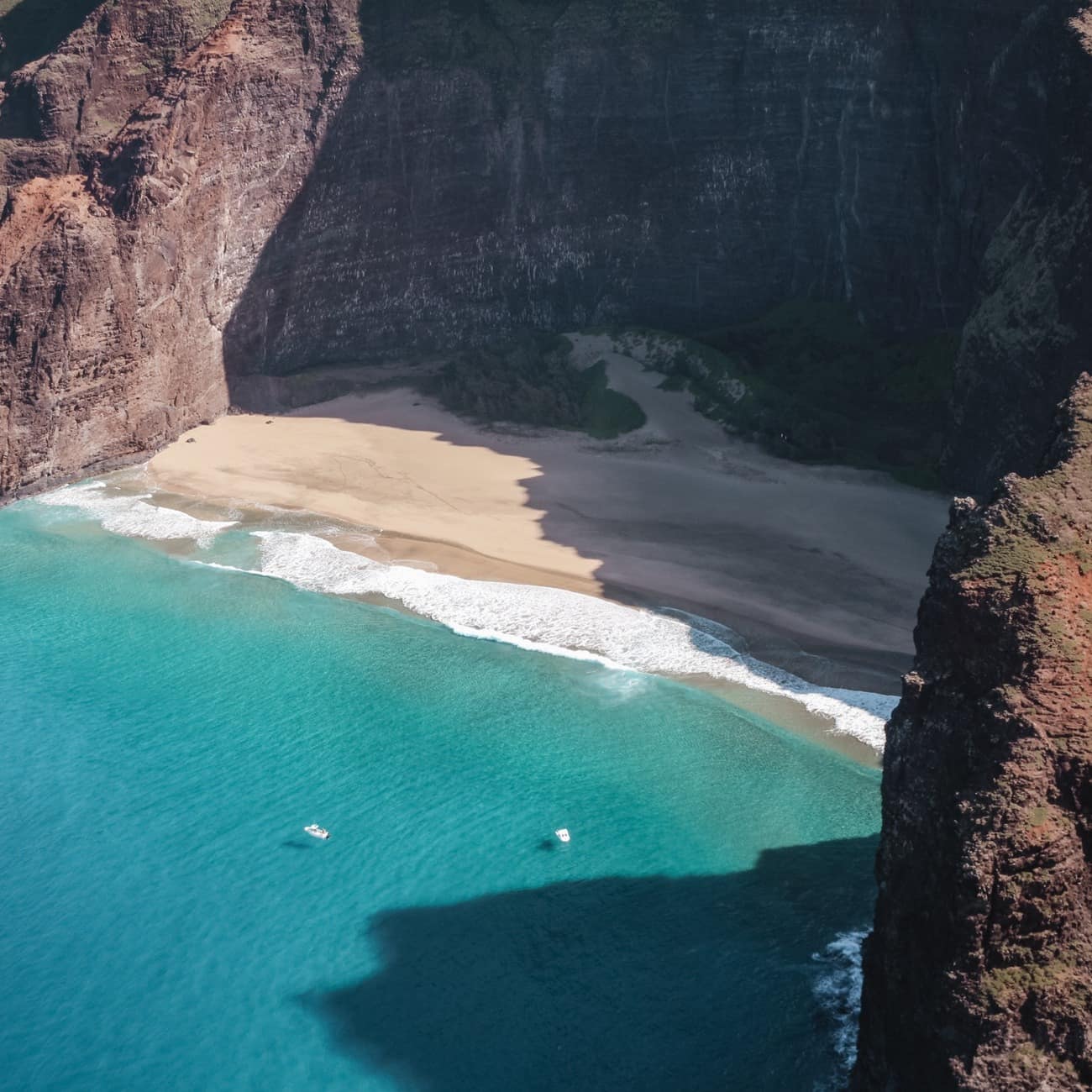 A dramatic cliff-backed cove on the coast of Kauai