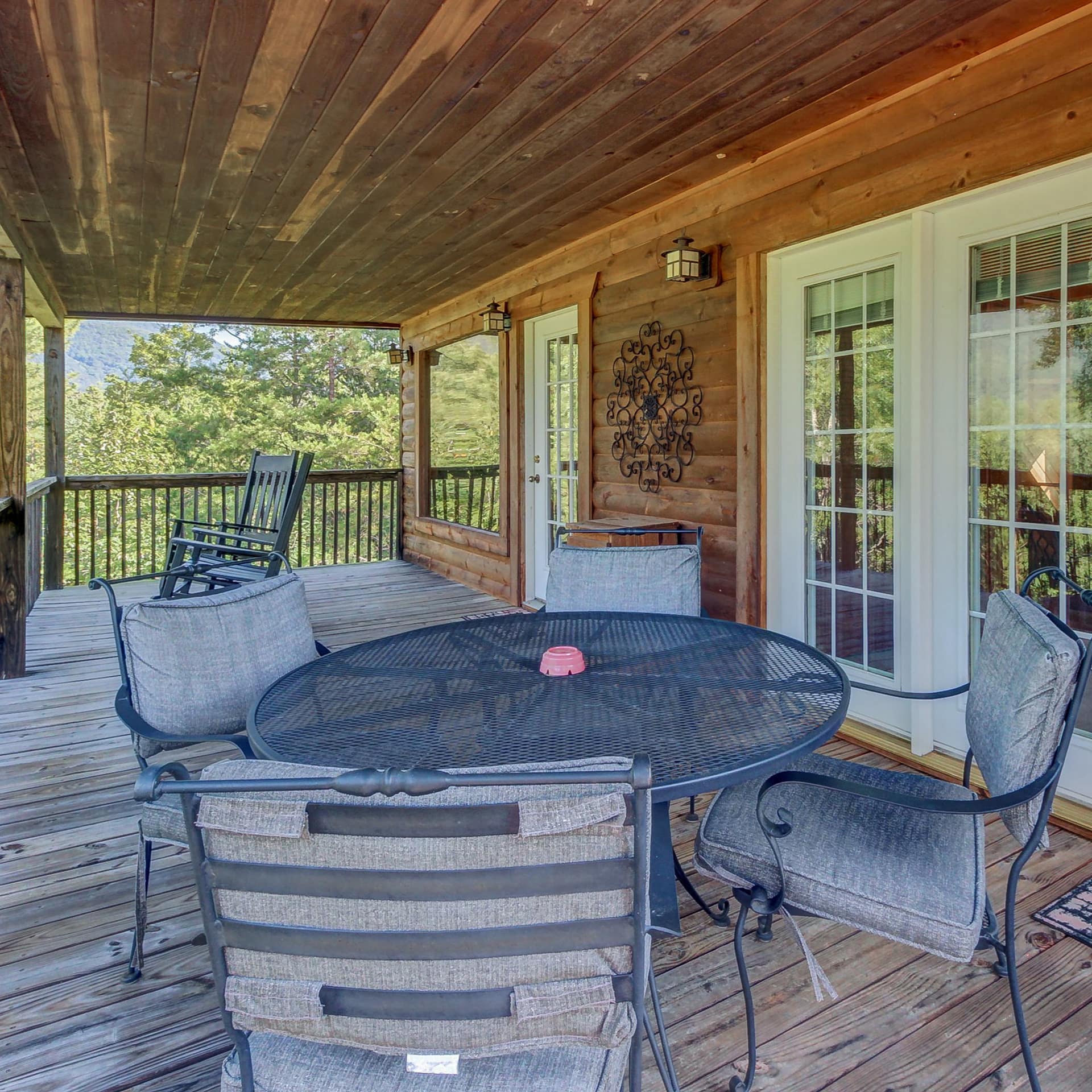 A rustic furnished porch offers sweeping views in Helen, GA.