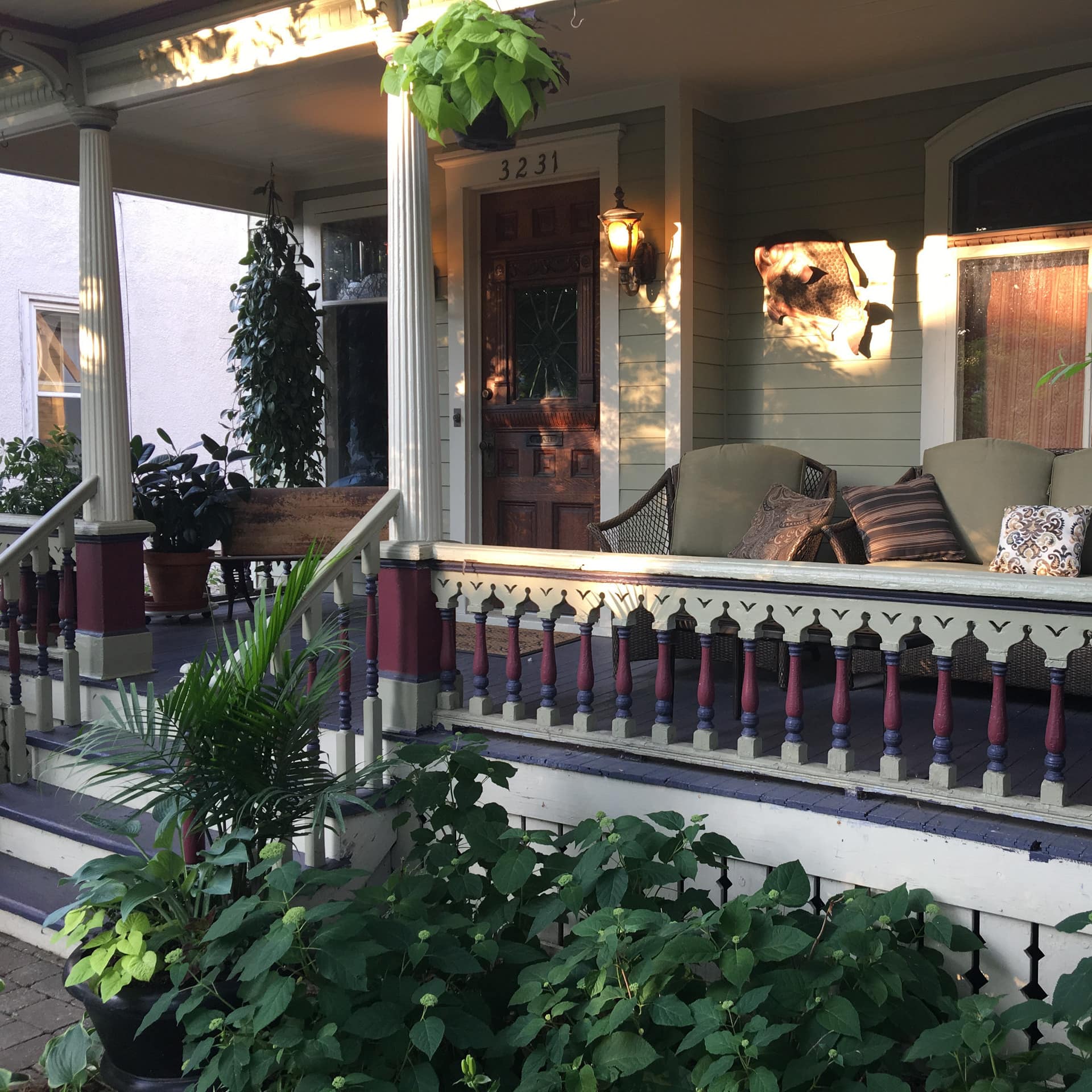 A leafy, furnished Victorian porch in the golden hour