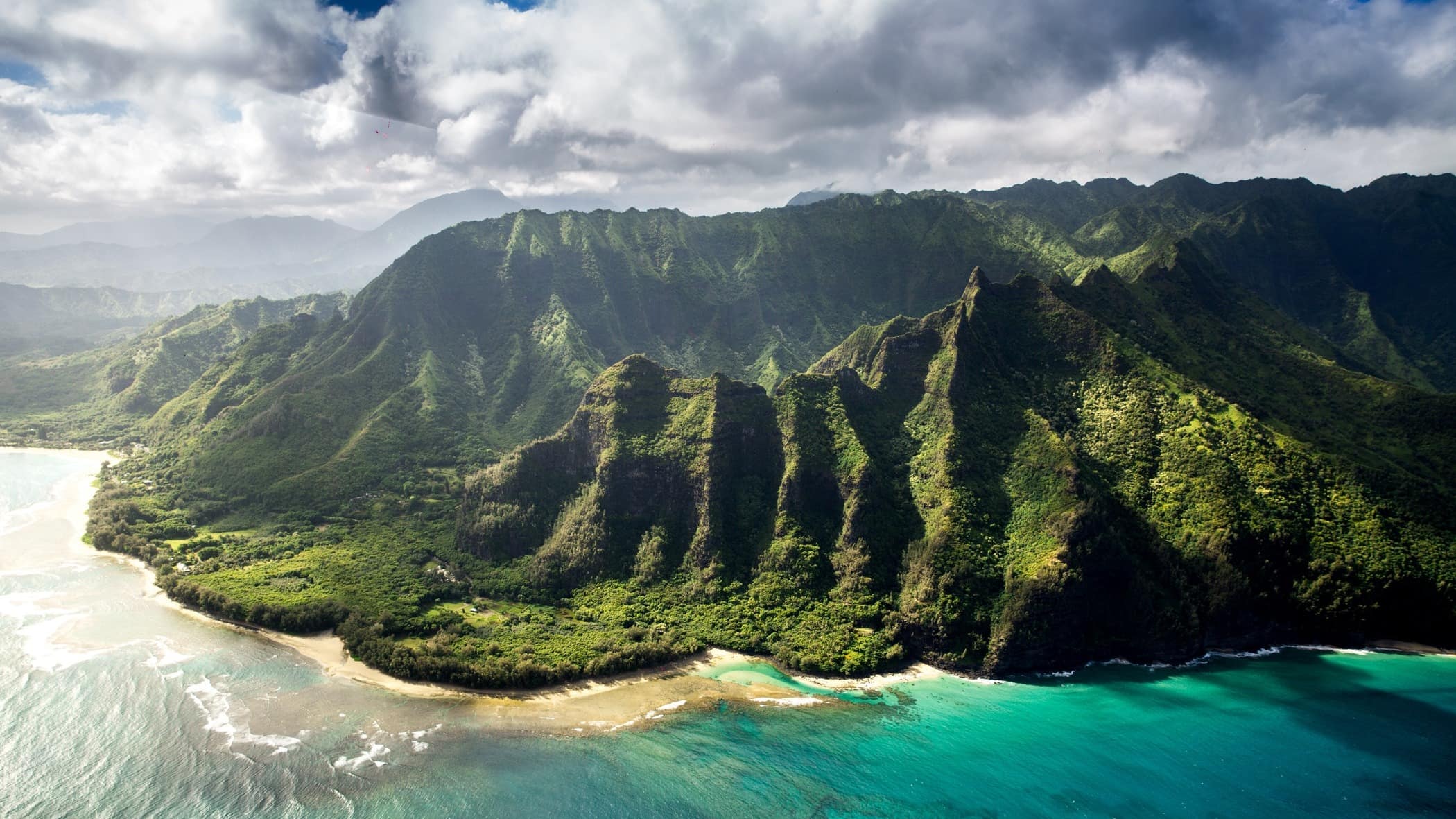 The rugged and wild coast of Kauai with golden beaches around its edge