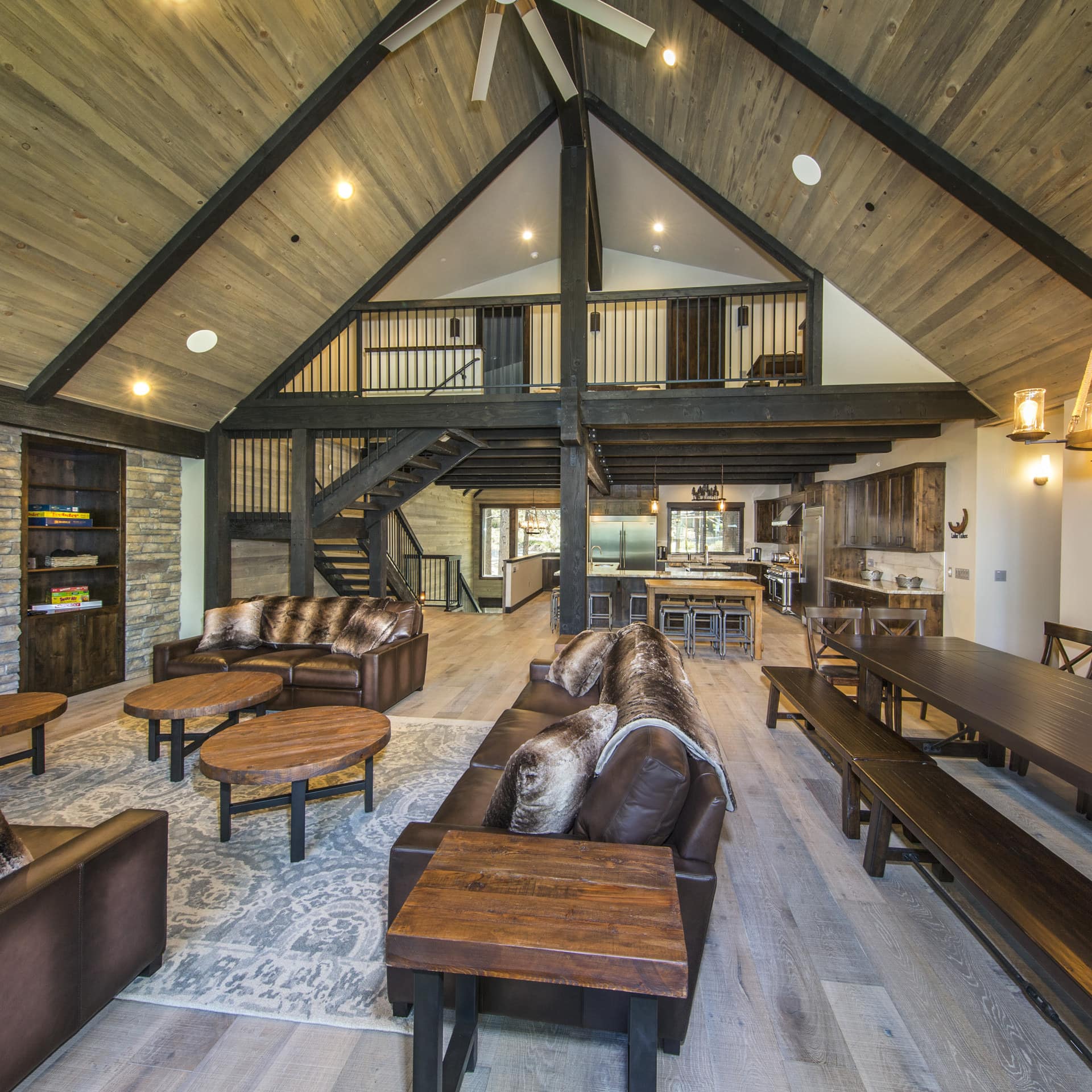 Sofas, long communal tables, and a loft in a large modern cabin