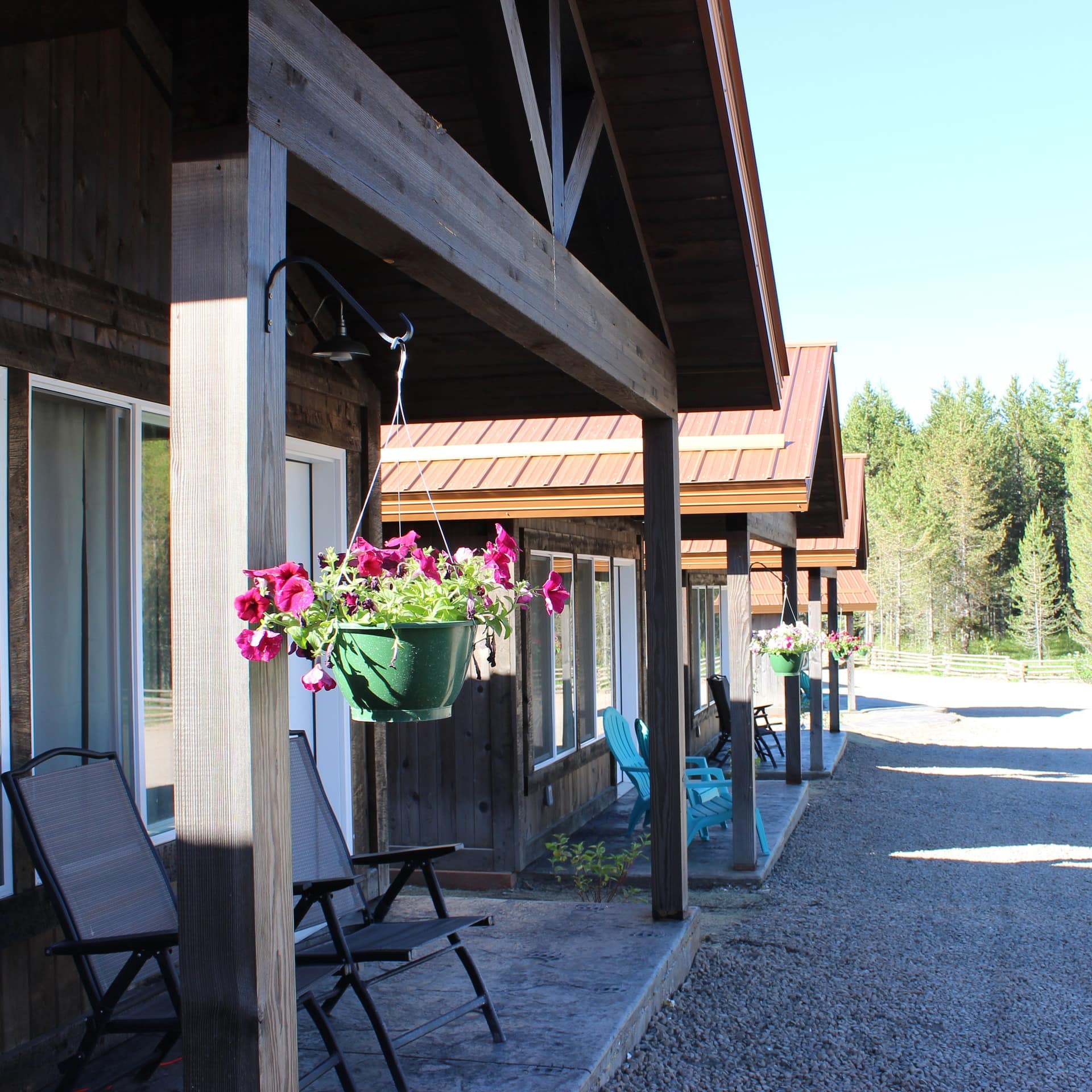 A row of wooden cabins, with porches