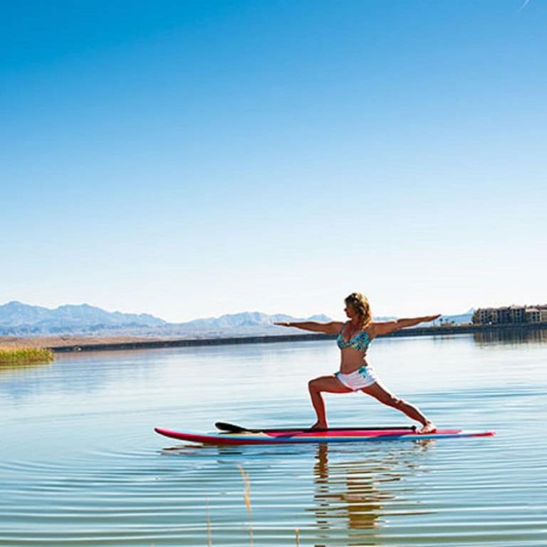 A woman practices paddleboard yoga on Lake Mead