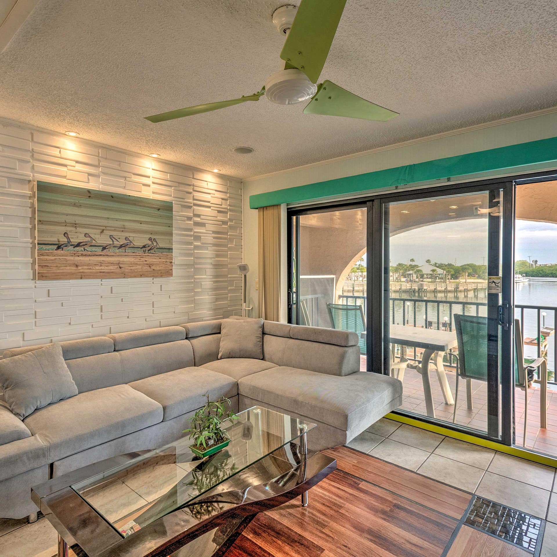The living room and terrace of a condo rental overlooking the water