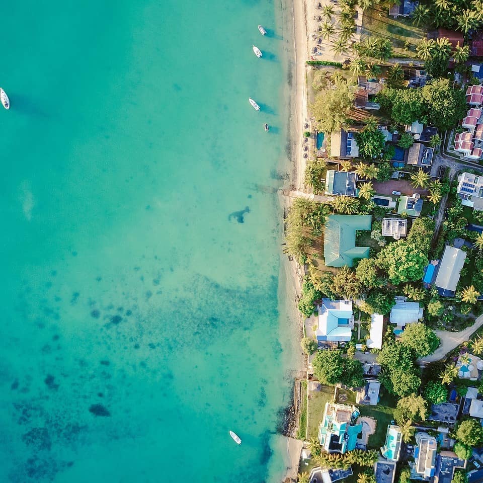 Houses fringe a stunning shoreline and a turquoise sea