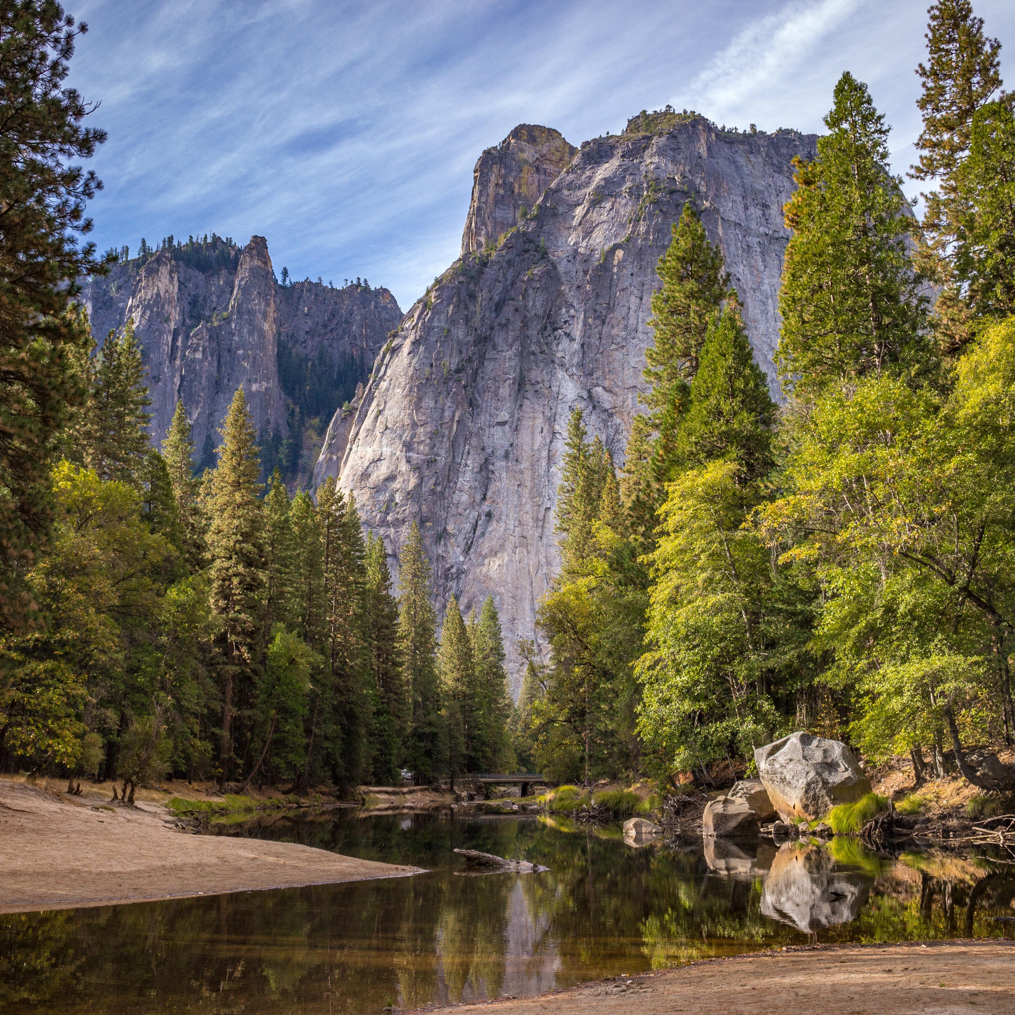 A stream, trees, and mountains in Yosemite National Park
