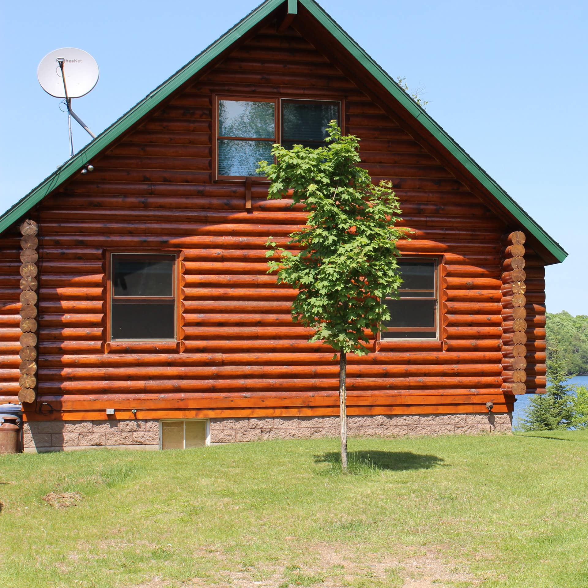 A traditional log cabin beside a lake