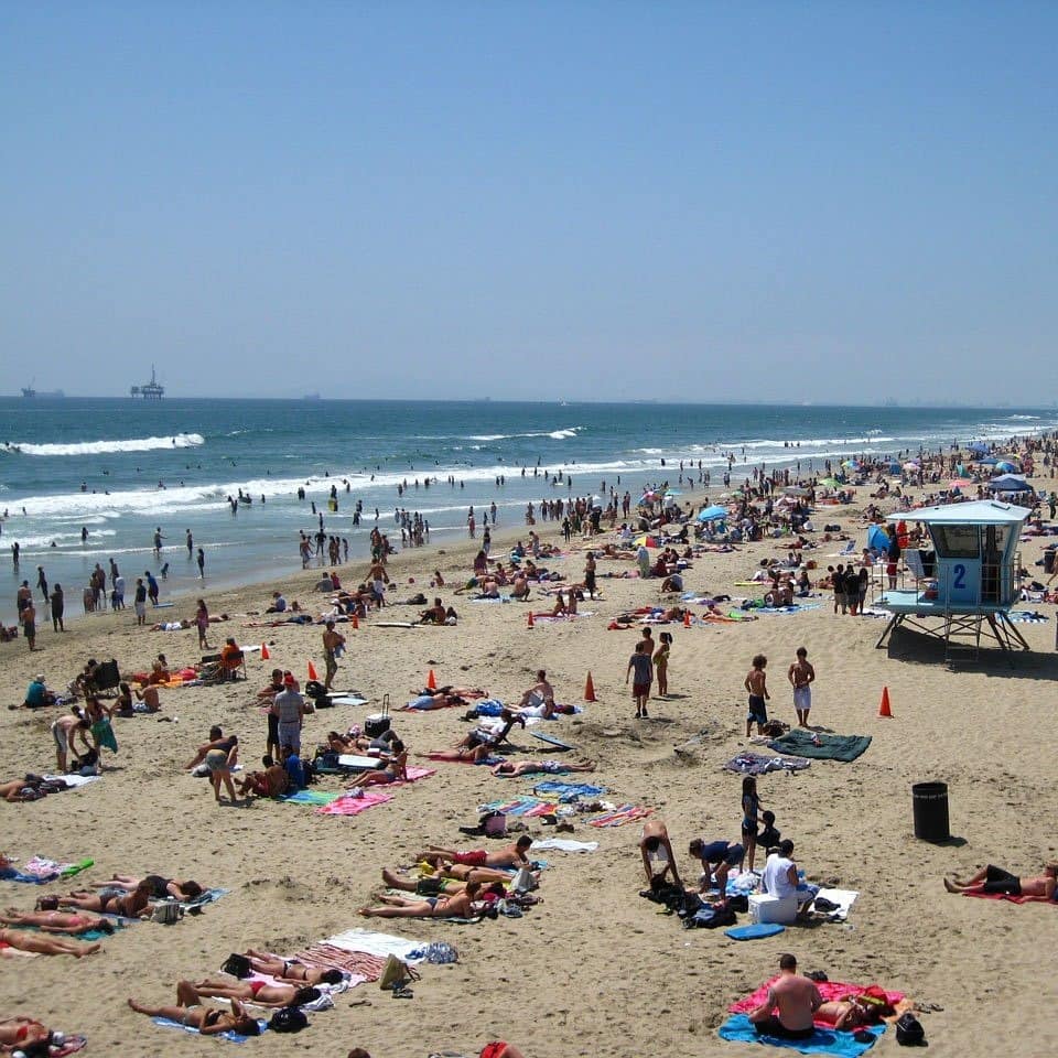 The main beach of Huntington Beach during the summer months is packed with people