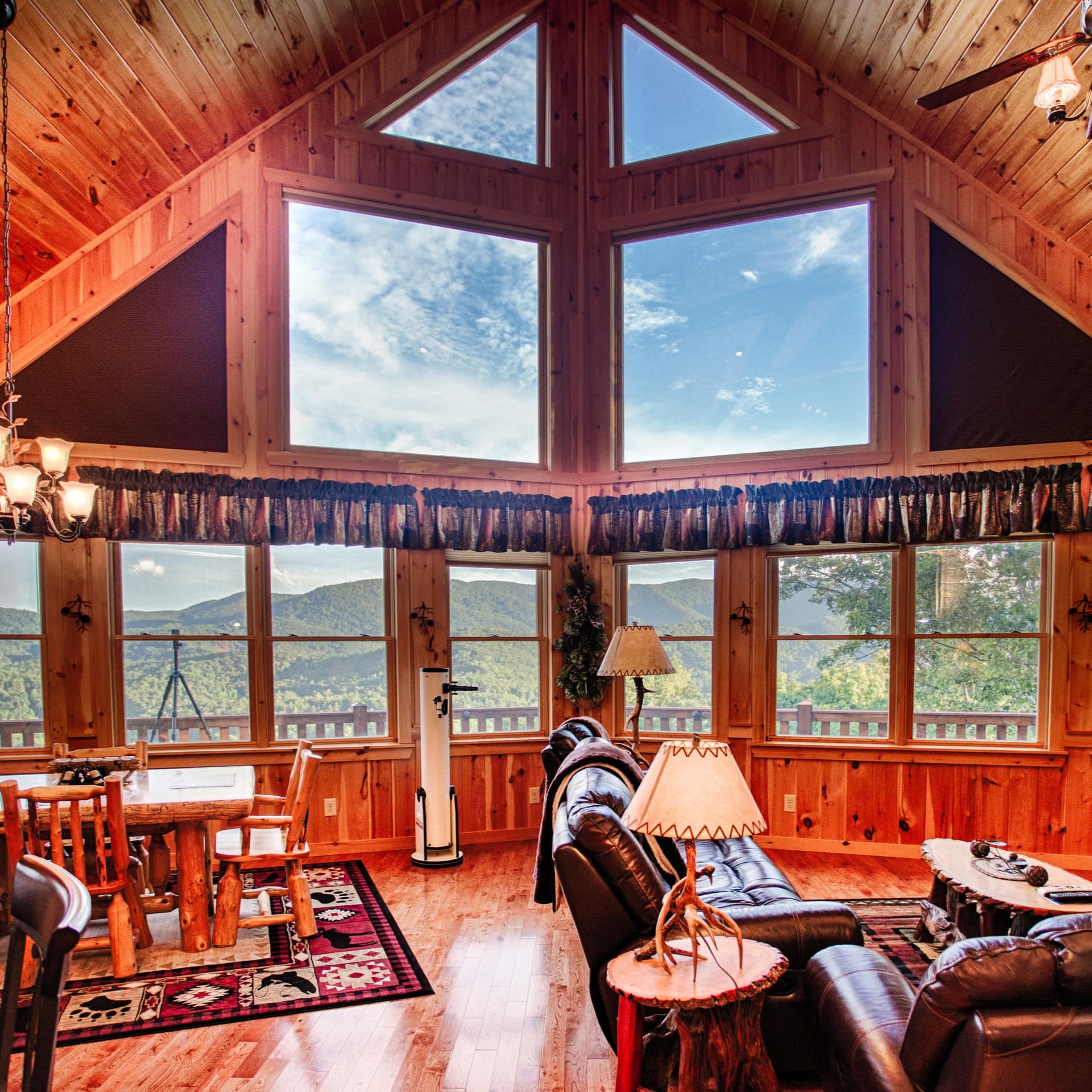 This luxury wooden cabin's several large windows make the most of the mountain views