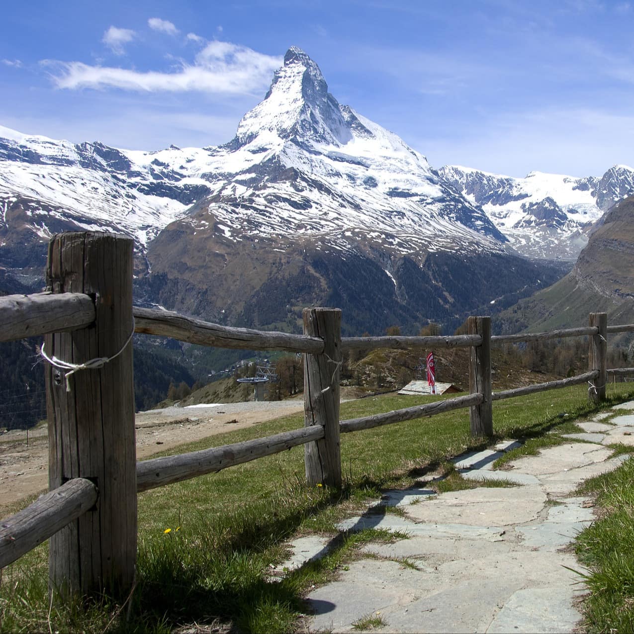 A hiking trail with views of the snowy Matterhorn.